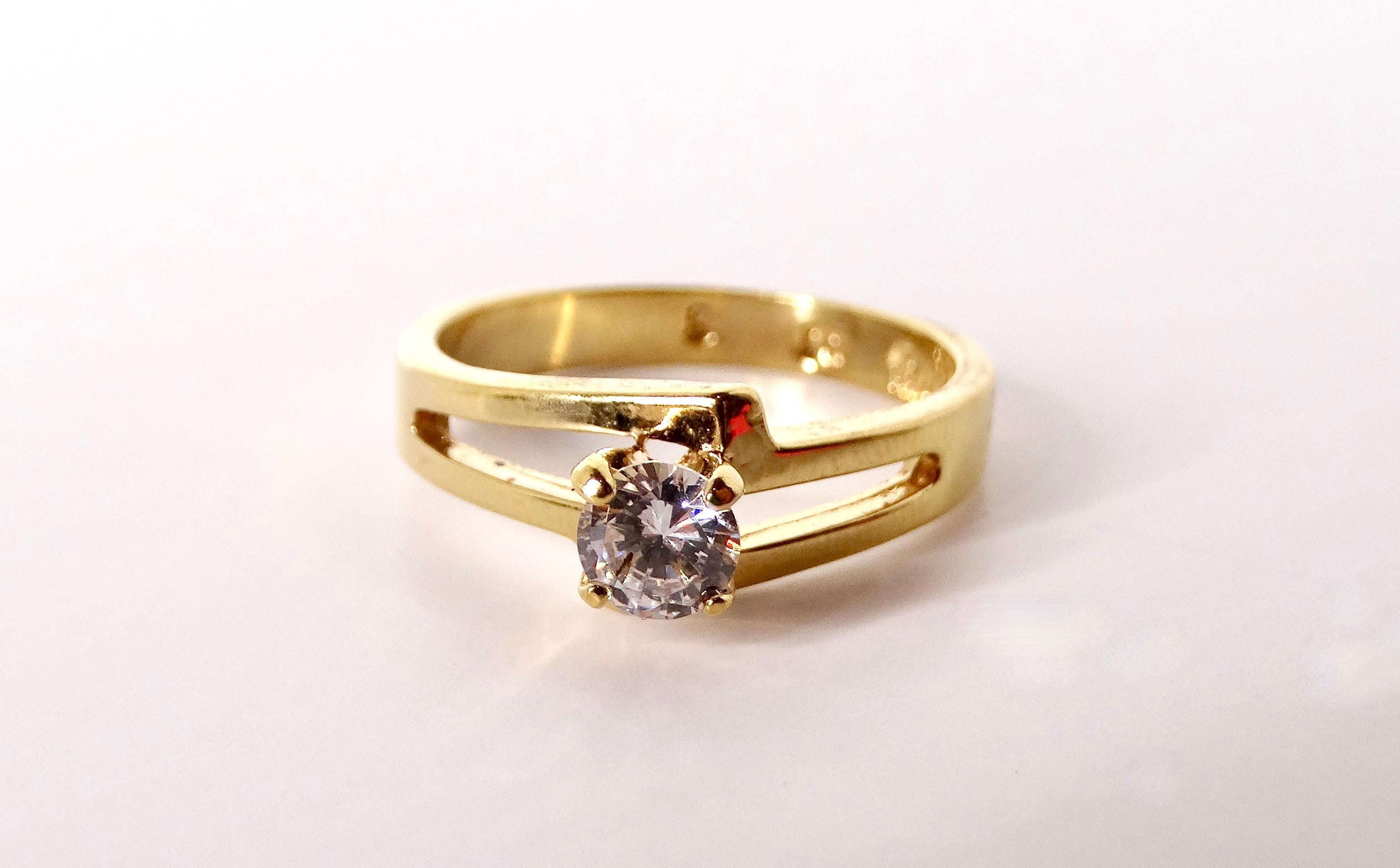 The Vintage Crystal Solitaire 14k Gold Plated Ring exudes timeless elegance and sophistication. Featuring a stunning crystal centerpiece, this ring combines classic design with a touch of modern glamour, making it a perfect accessory for any