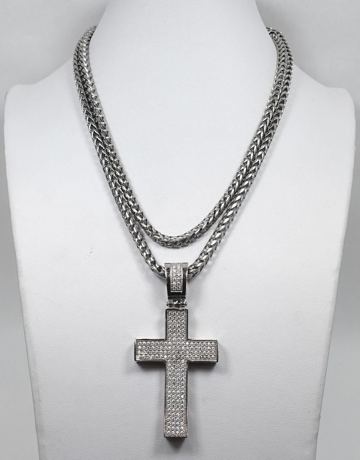 This vintage necklace features a cross filled with beautiful clear crystal in a sterling silver setting.  The pendant measures 3-1/4” x 1-3/8”.  The thick chain is 34” with a spring closure x 3/16” wide.  This vintage cross pendant necklace is in