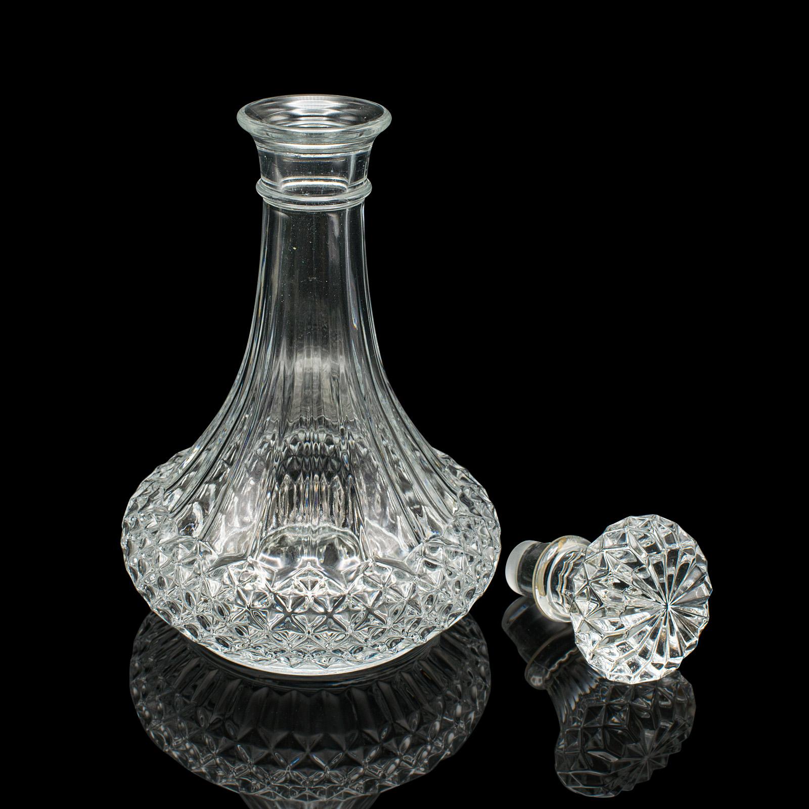
This is a vintage crystal wine decanter. An English, cut glass decorative spirit vessel, dating to the mid 20th century, circa 1960.

Striking form and patterns accentuate this appealing decanter
Displays a desirable aged patina and in good