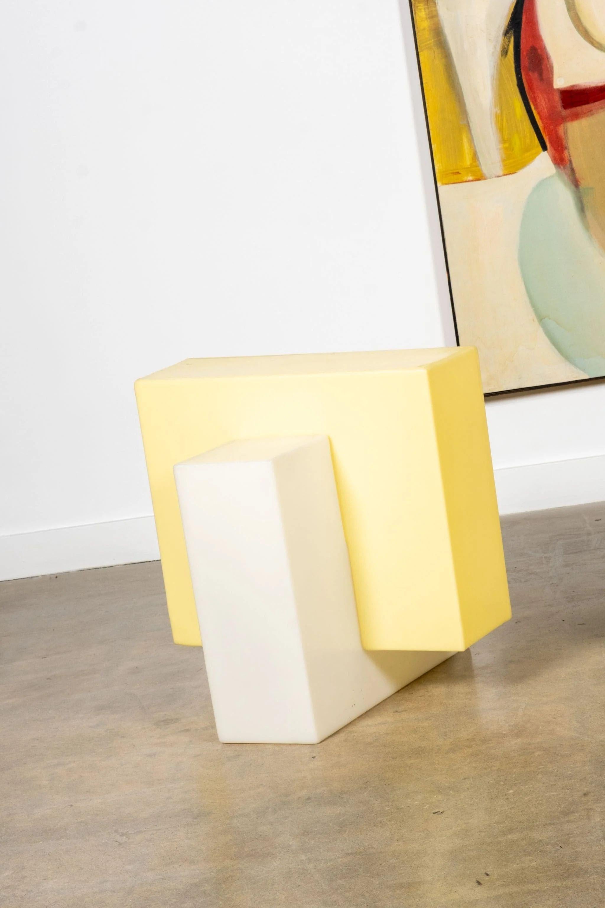 Like building blocks for grown-ups. This large cube floor lamp stacks bold geometric forms in sunny yellow and cream, striking the perfect balance between playful and architectural. Its glossy plastic finish and sculptural silhouette give it an
