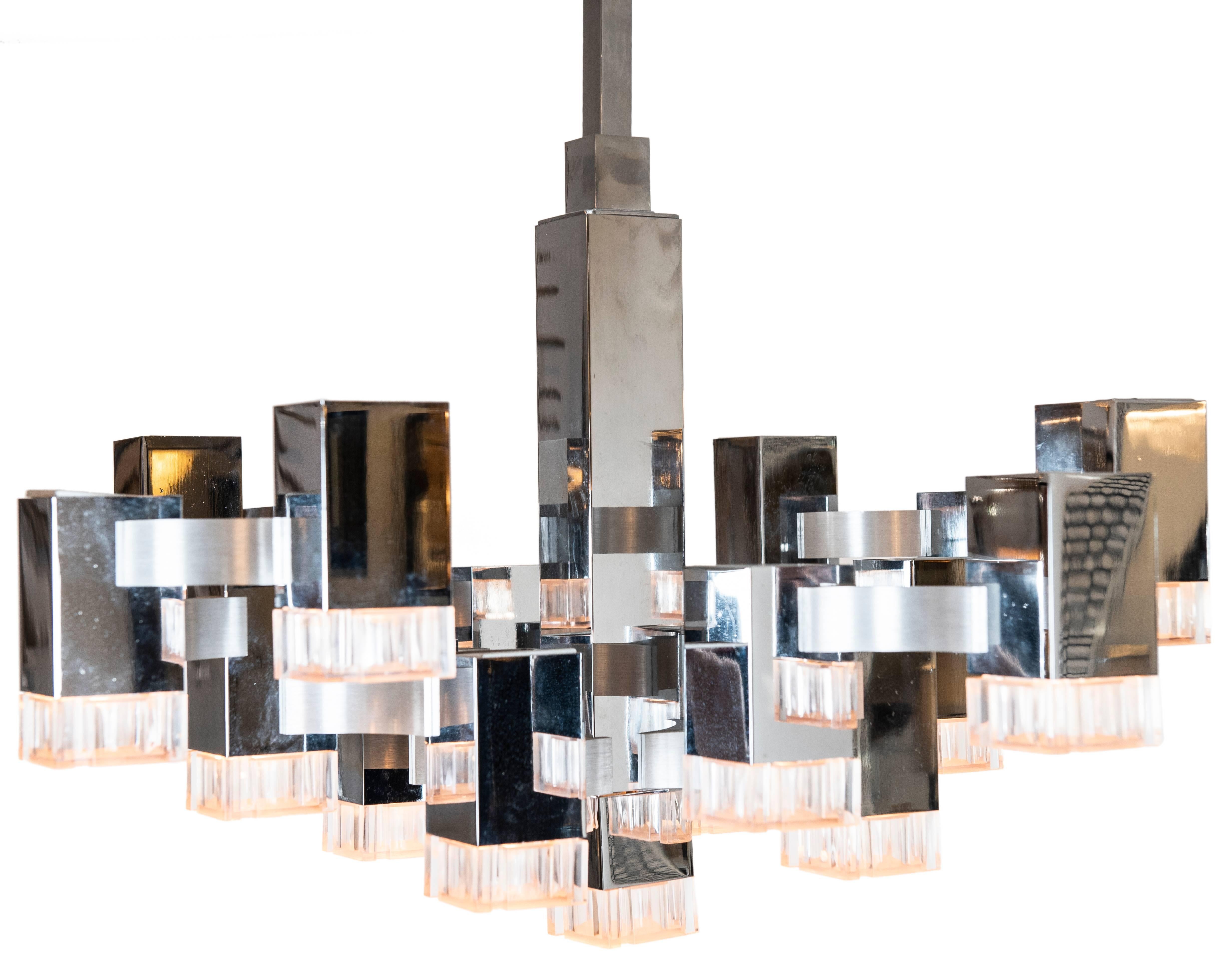 This iconic and cool 17 light Sciolari pendant with chromed metal mounts and acylic shades. It has its original chrome mounting pole and matching canopy. The poles may be removed in order to flush mount the fixture (s) if so desired. The overall