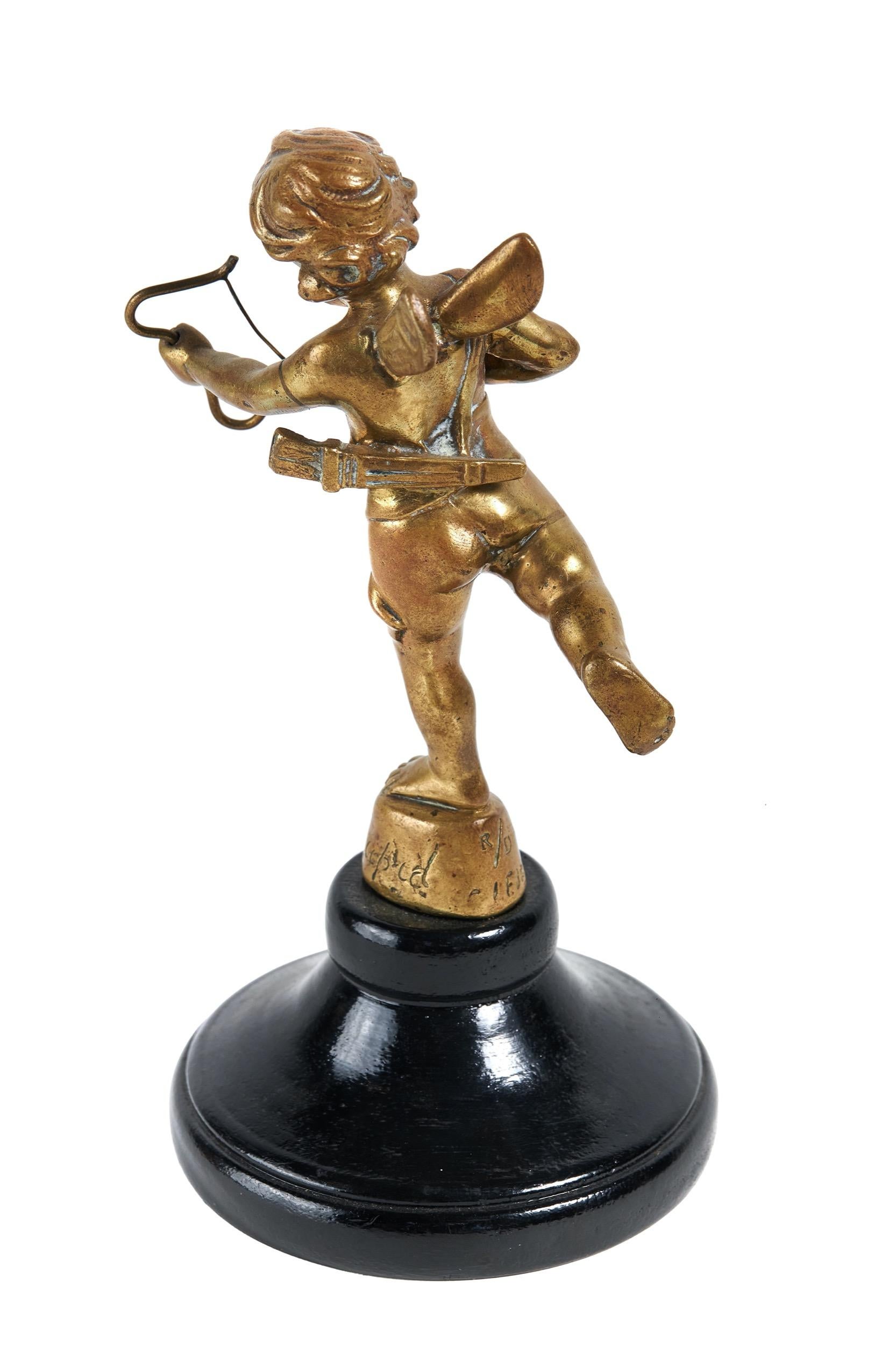 Vintage  Cubitt car mascot in the form of  brass Cupid with bow & arrow,stamped Cubitts Cupid, R/D LE JEUNE
Cast Brass 
original car mascot 1920s
Dimensions: Cupid Figure H 13.5cm x W 10cm
Mounted On Black Painted Wood Turned Base