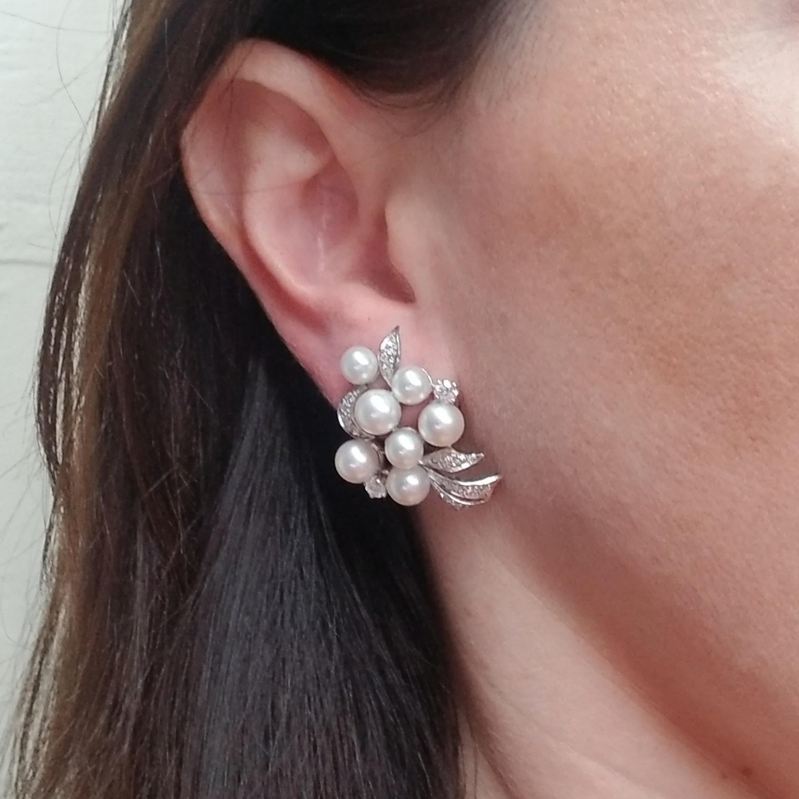 14 Karat White Gold Earrings Featuring a Cluster of 14 White Cultured Pearls of Varying Sizes and 36 Round Diamonds Totaling Approximately 1 Carat of VS Clarity & G Color. Each Earring Is Designed with a Leaf Motif that Bends in a Different