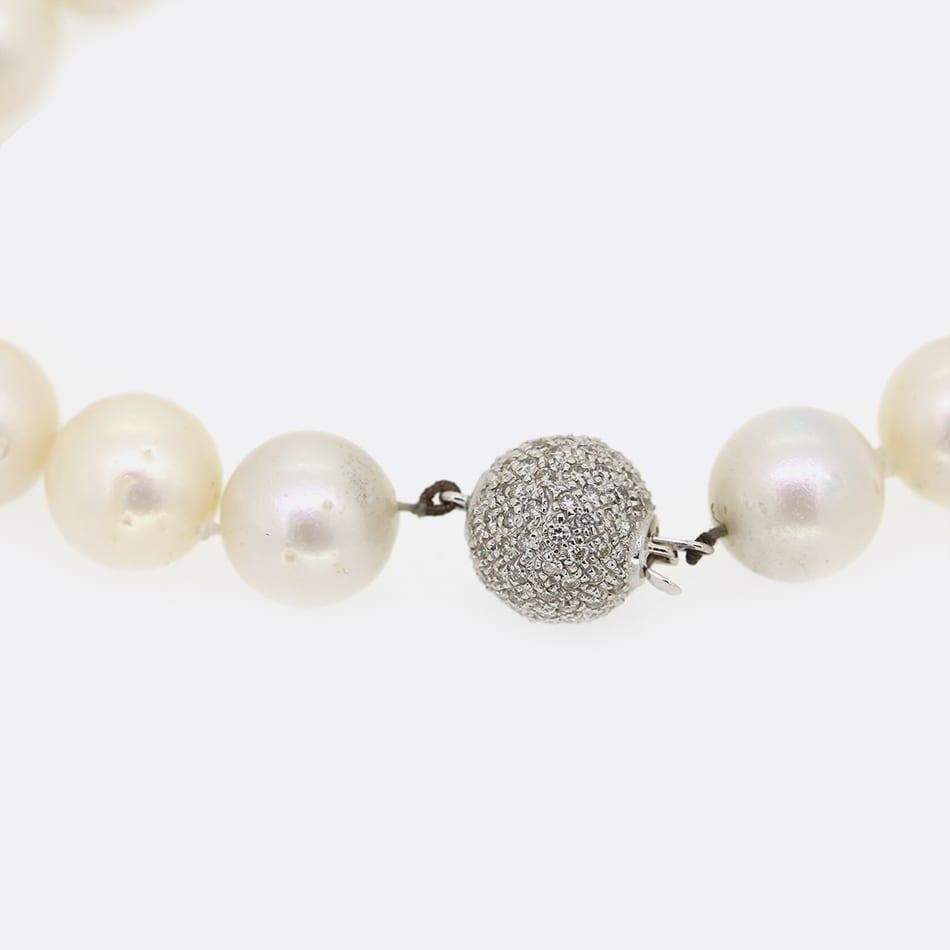 This is a classic south sea cultured pearl necklace. The necklace is formed of 37 large 12mm cultured pearls and an 18ct white gold diamond ball clasp that is also 12mm. 

Condition: Used (Very Good)
Weight: 107.2 grams
Length: 20 inches