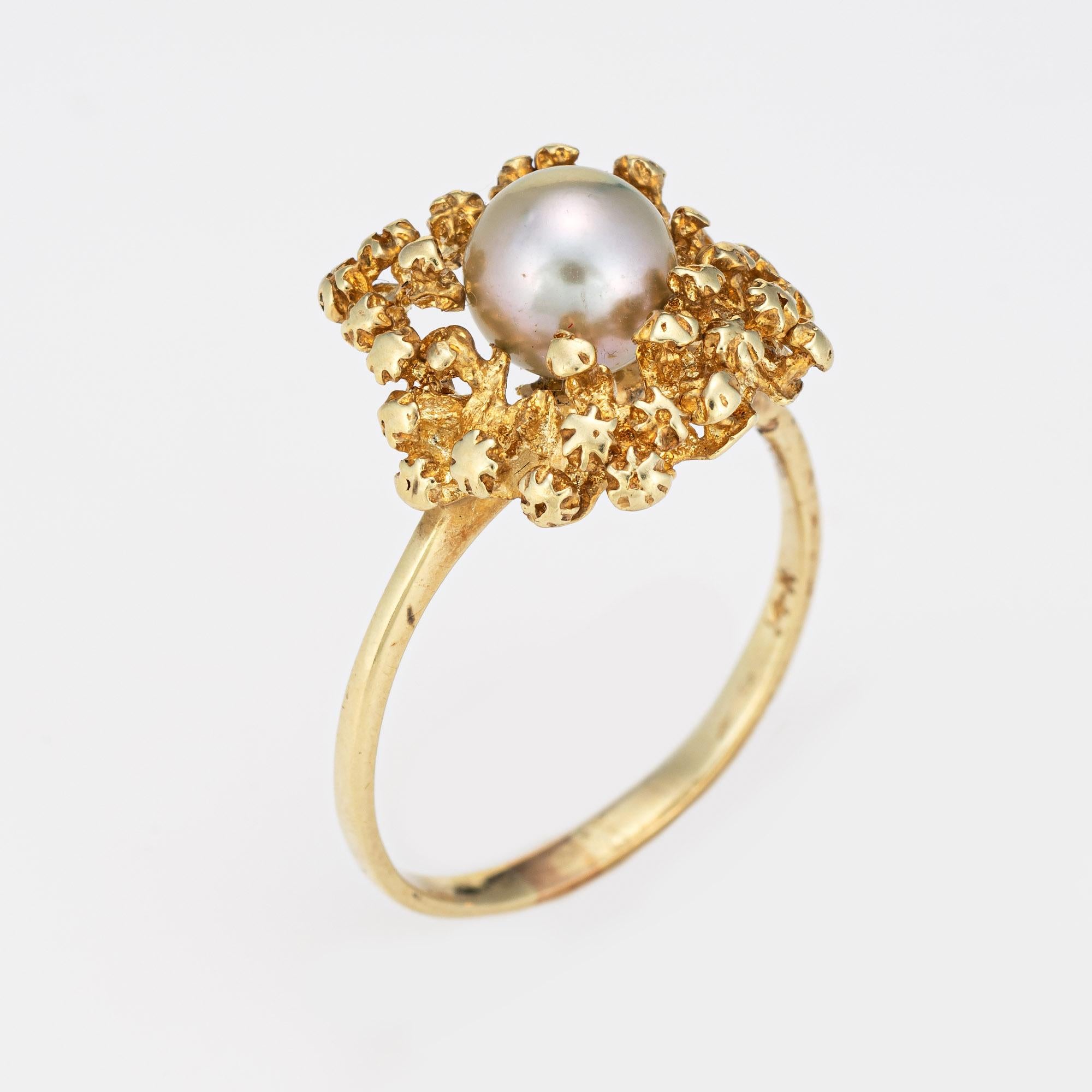 Stylish vintage cultured pearl ring (circa 1970s) crafted in 14 karat yellow gold. 

One 6.5mm cultured pearl is set into the mount. The pearl is a light silver grey color and exhibits good luster.  

The soft grey pearl is set into an abstract