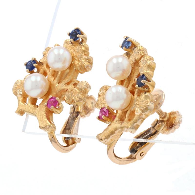Add a touch of vintage elegance to your modern wardrobe with these earrings! Crafted in 14k yellow gold, this pair of stud-style earrings display a beautifully sculpted botanical motif graced by creamy white cultured pearls, vibrant blue sapphires,