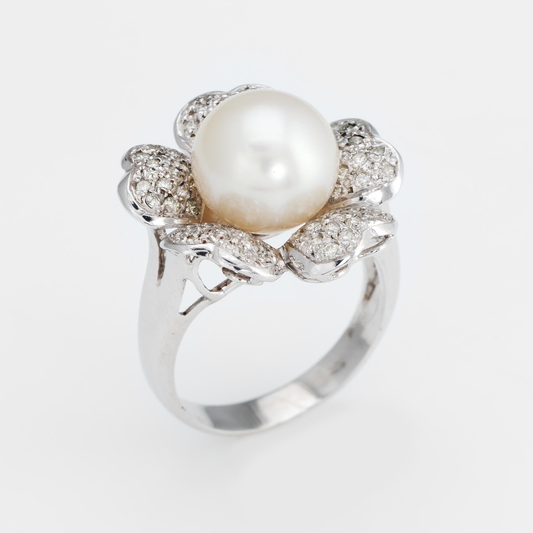 Finely detailed vintage South Sea cultured pearl and diamond cocktail ring, crafted in 14 karat white gold. 

Cultured white South Sea pearl measures 10.5mm, accented with an estimated 0.40 carats of diamonds (estimated at H-I color and SI1-2