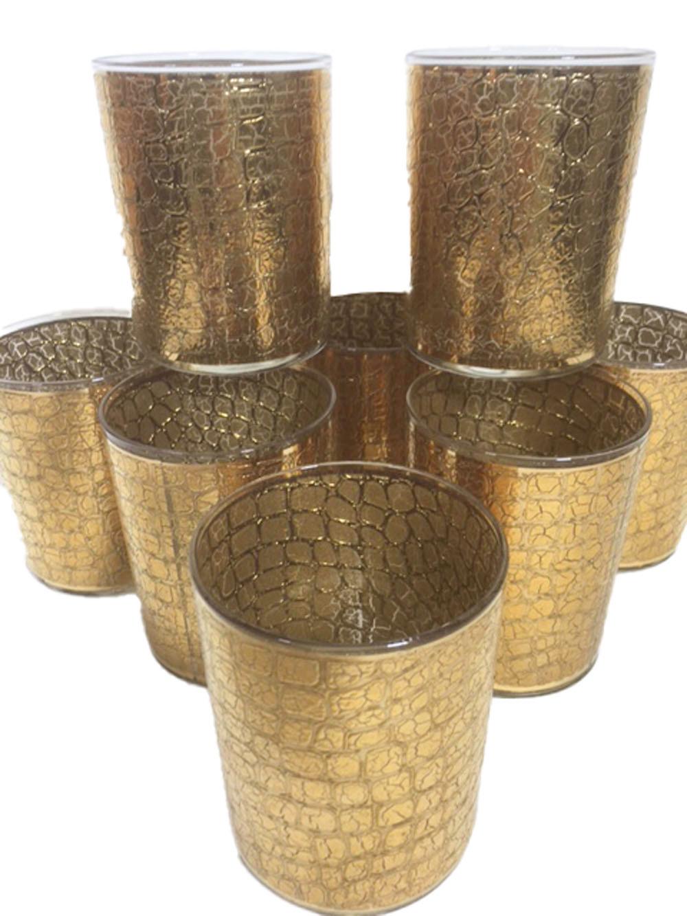 Eight Mid-Century Modern rocks glasses made by Culver Glassware Co. Each wrapped in 22k gold embossed with an alligator skin pattern. All in excellent condition.
