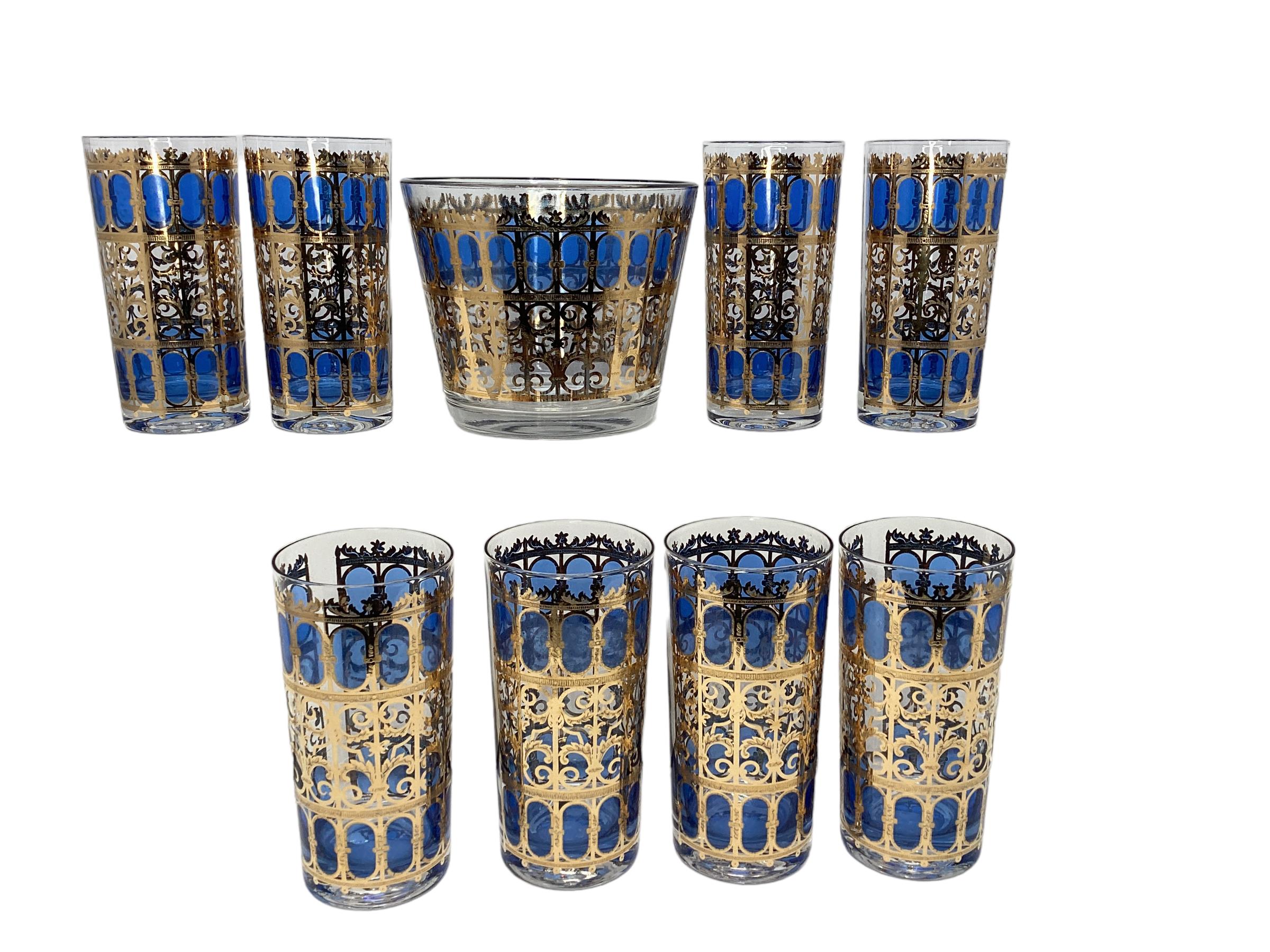 Vintage Culver Cobalt Scroll Cocktail Set, 8 Highball Glasses and Ice Bucket. 22-karat gold filigree scroll work in a Moorish inspired windows pattern with blue ovals filling each window. All in excellent vintage condition.
Glasses 2.75