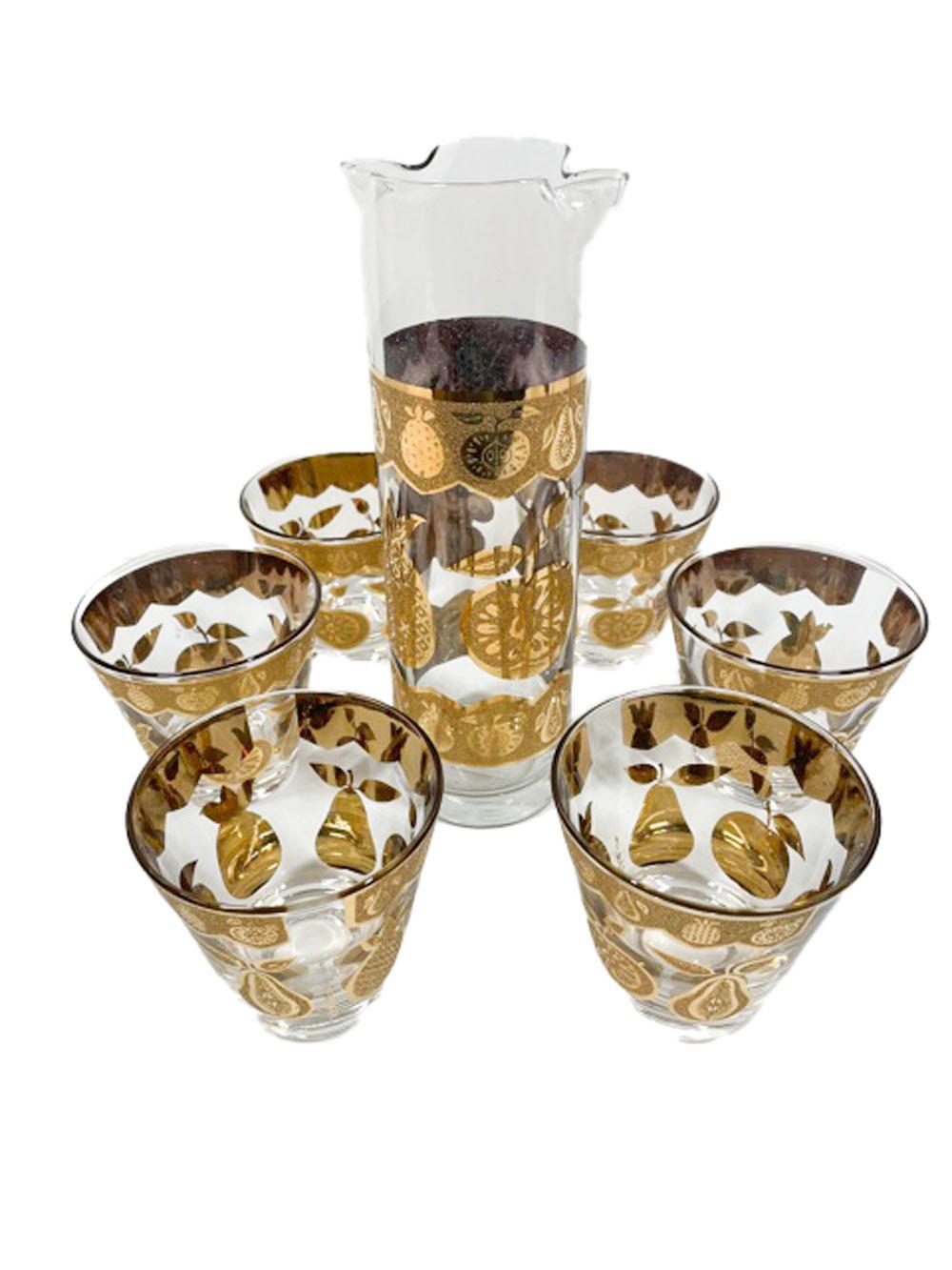 Mid-Century Modern cocktail set by Culver in the Florentine pattern, decorated in smooth and textured 22k gold depicting apple, pear, pineapple and grapes. The set consists of a cocktail pitcher and six old fashioned glasses.