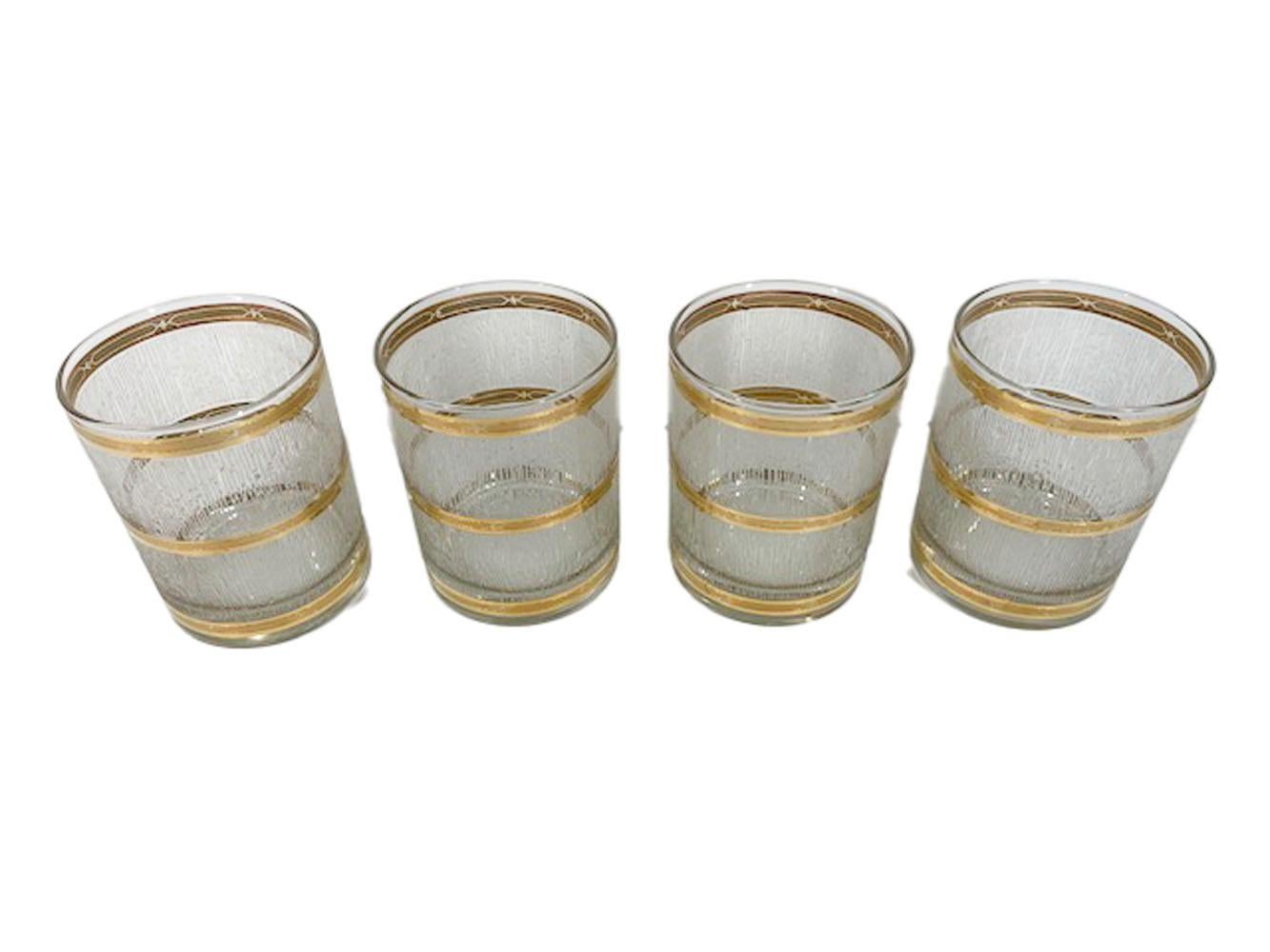 Mid-Century Modern rocks glasses by Culver, LTD in the Icicle pattern having 22 karat gold bands bordering wide bands of raised translucent 