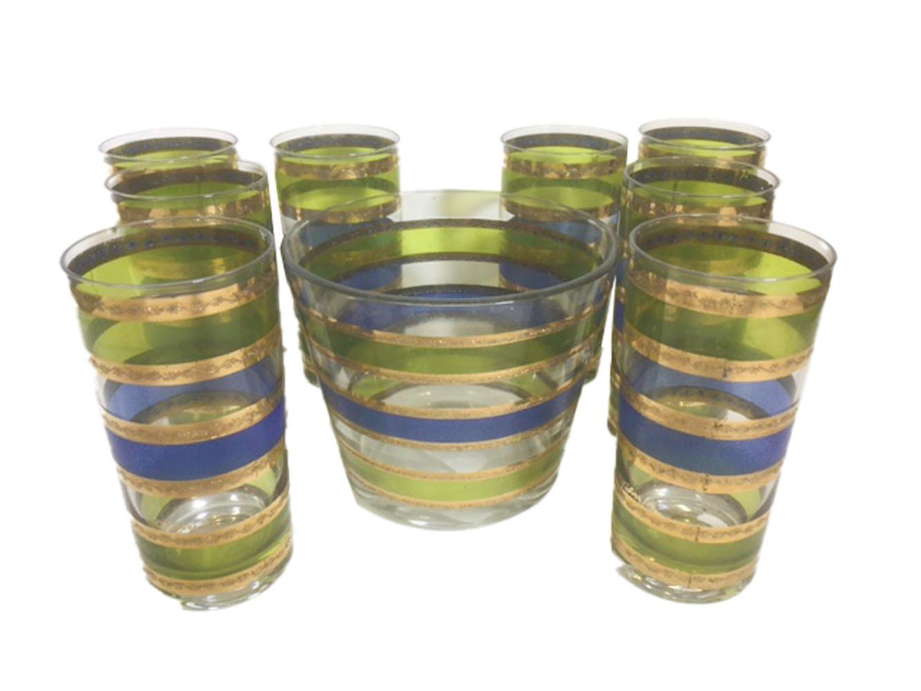 Mid-century Culver glassware ice bowl and 8 highball glasses in the Rondo pattern. Each piece with bands of translucent green and blue enamel on clear glass with raised lines of 22k gold separating each band.

Measures: Ice bowl: 5