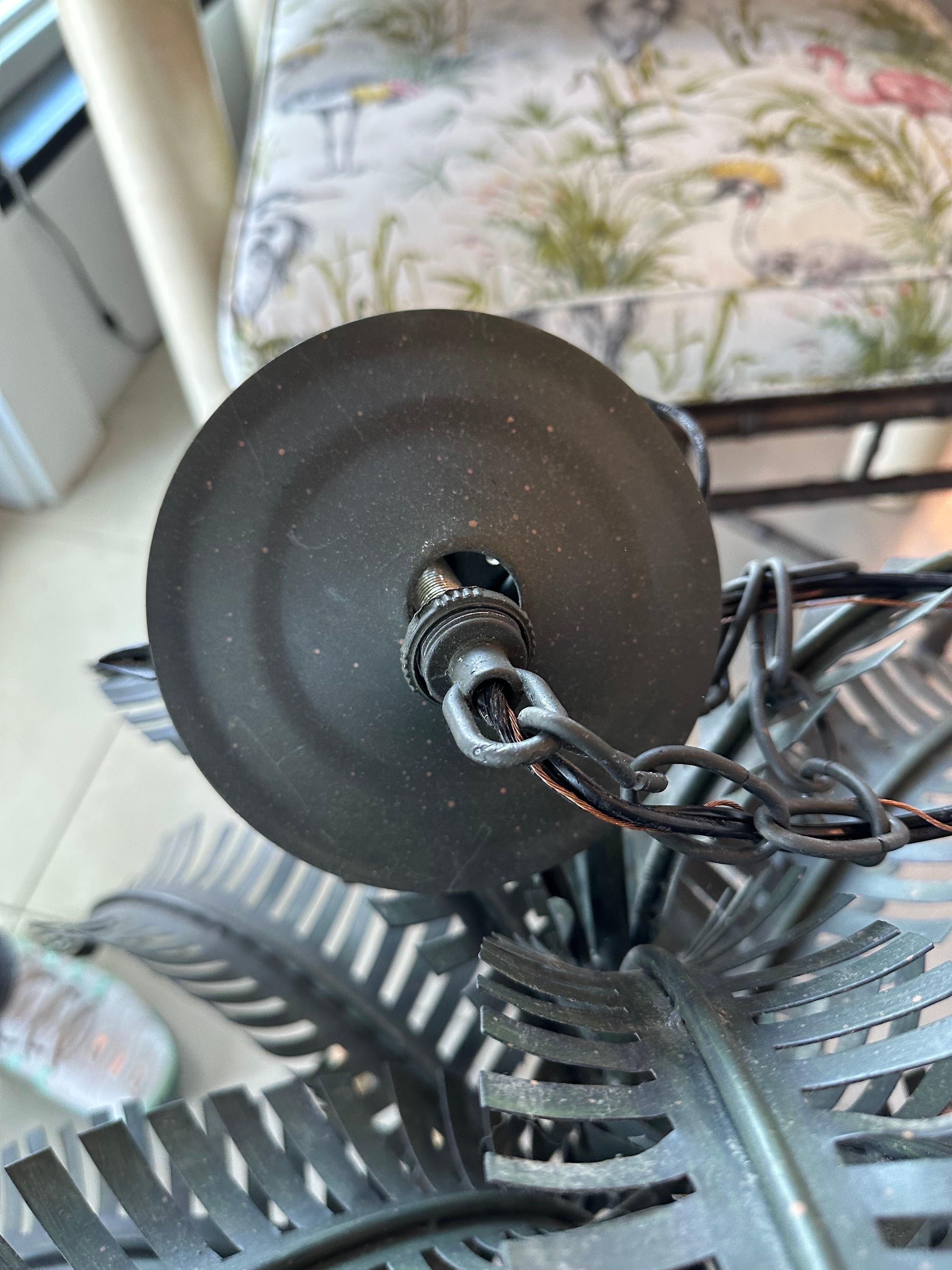 Vintage metal tole palm tree leaf frond 12 light chandelier. Tested and working order. Dimensions: 34 H x 31 D. Comes with original ceiling cap.