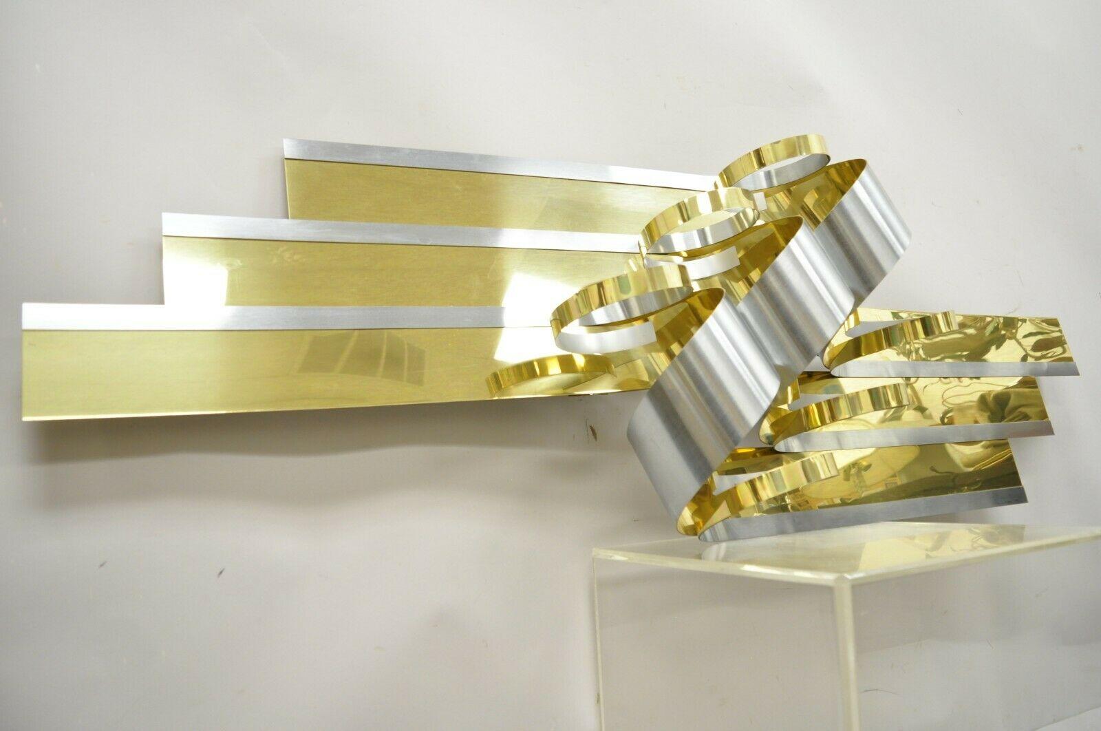 Vintage Curtis Jere 1989 brass ribbons 100682 large wall art sculpture. Item features original paper work, brass and steel construction, larger impressive size, signed to corner, very nice vintage item, quality American craftsmanship, great style