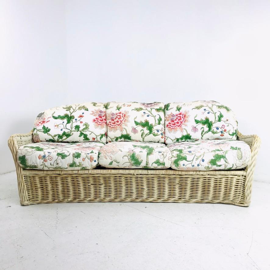 Unique vintage curved woven wicker sofa in the style of Wicker Works, circa 1980s. Heavy and very sturdy. No breaks or damage to wicker - fantastic vintage condition! Would look amazing with fresh upholstery.