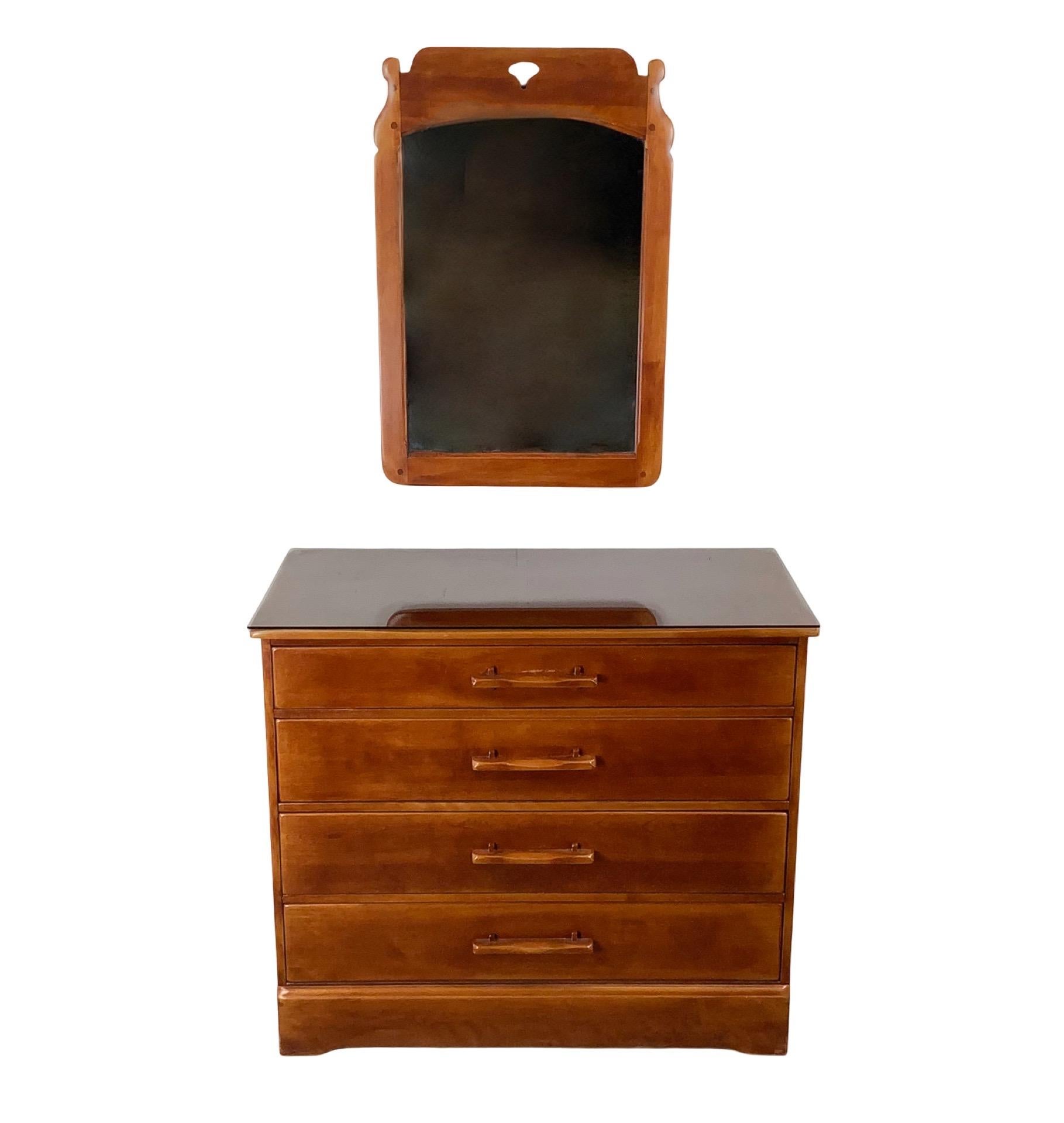 This vintage four-drawer dresser from Cushman Furniture showcases the refined simplicity and enduring quality for which the company is known. Finished in a warm cherry tone, the dresser is distinguished by its wide, sculptural drawer handles that
