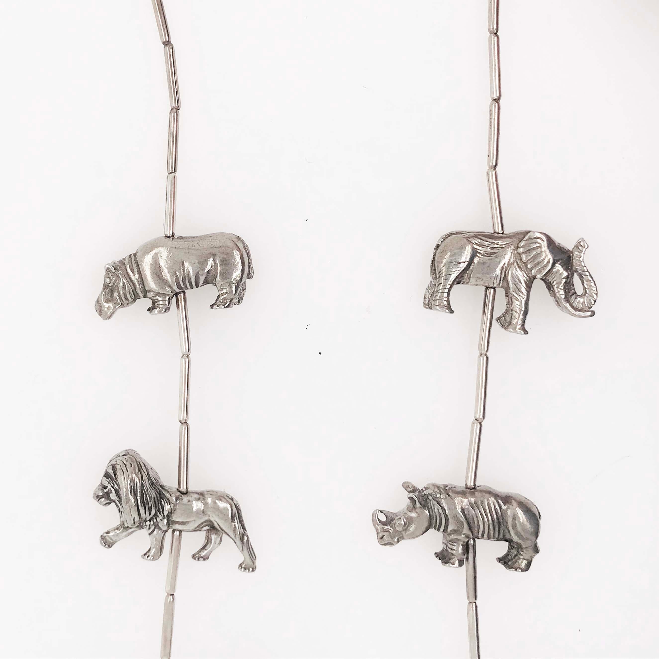 This unique necklace is a vintage piece that has nine 3-D African safari animals that have been hand crafted and created into this beautiful fine jewelry piece. Each animal has great detail work. The animals are rhinoceros, giraffes, zebras,