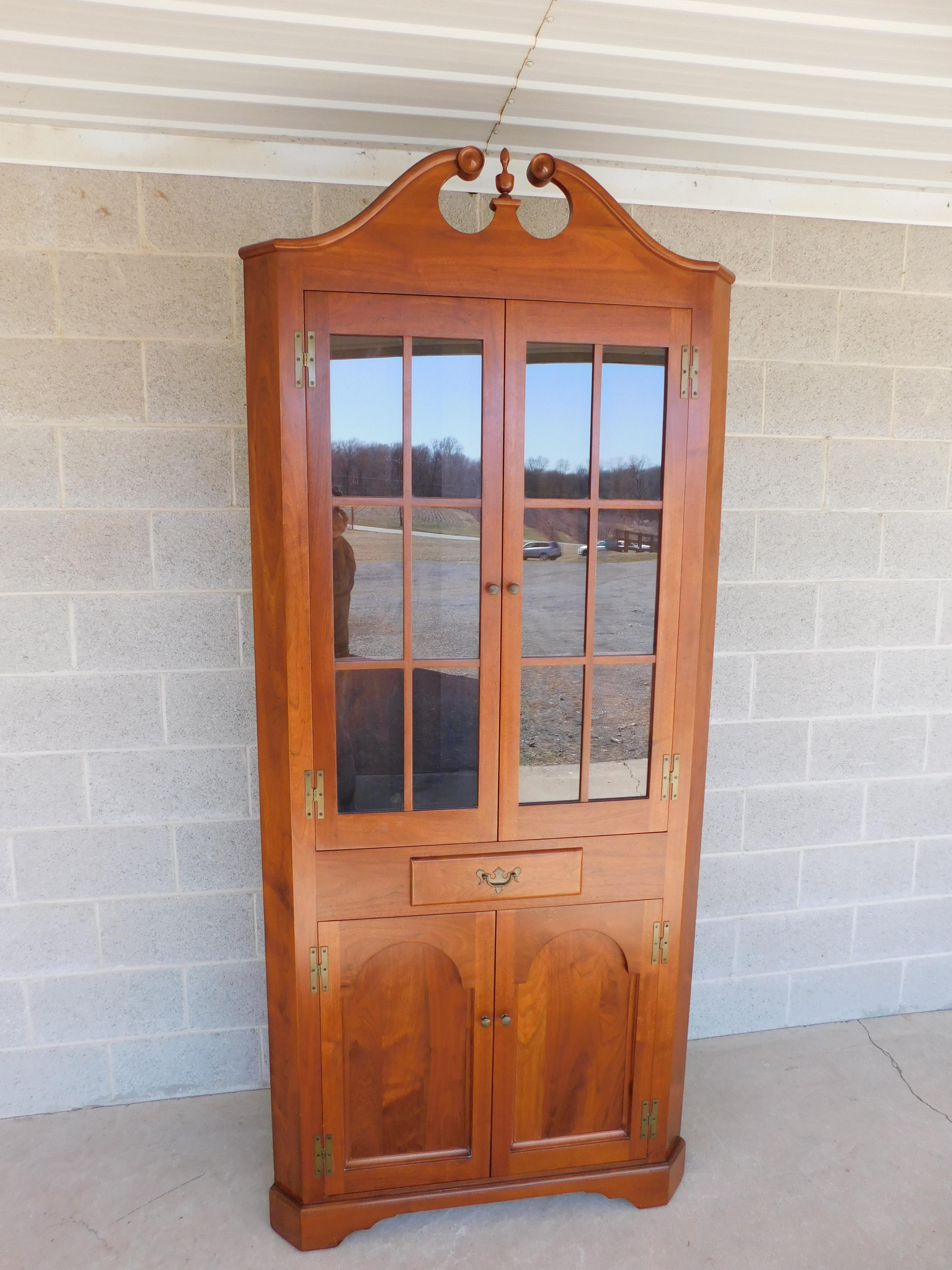 Features Quality handmade construction, beautiful black walnut wood grain, ( not signed ),broken arched pediment with finial, deep recessed panel doors, single dovetailed drawer, brass 
