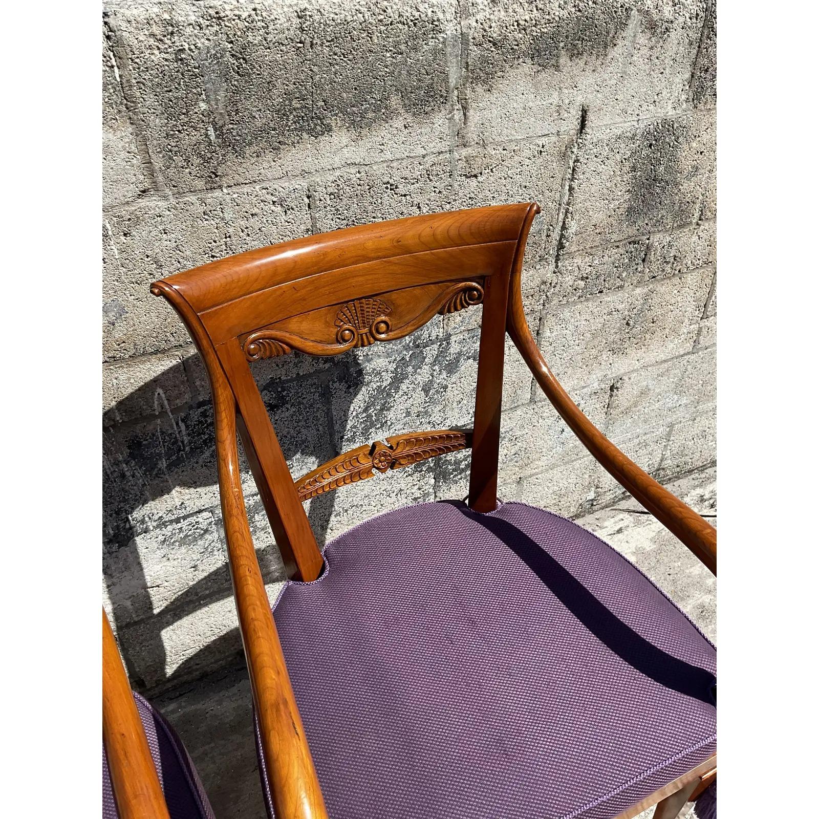 A stunning pair of vintage custom built arm chairs. Hand made by the prestigious KPS group in Italy. Beautiful warm wood with hand carved detail. Inset cane panel with custom upholstery in rich purple. Acquired from an immaculate Naples estate.