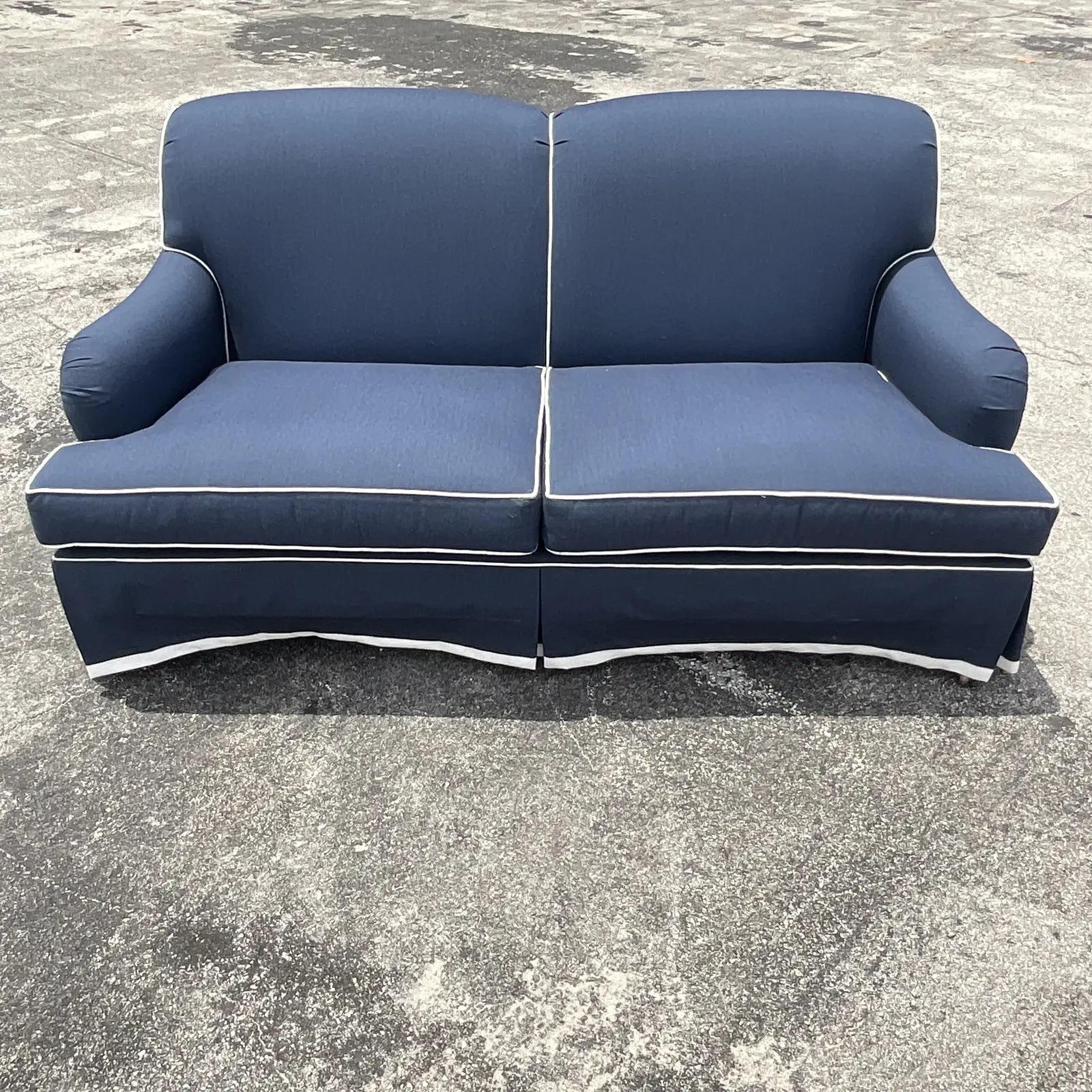 blue sofa with white piping