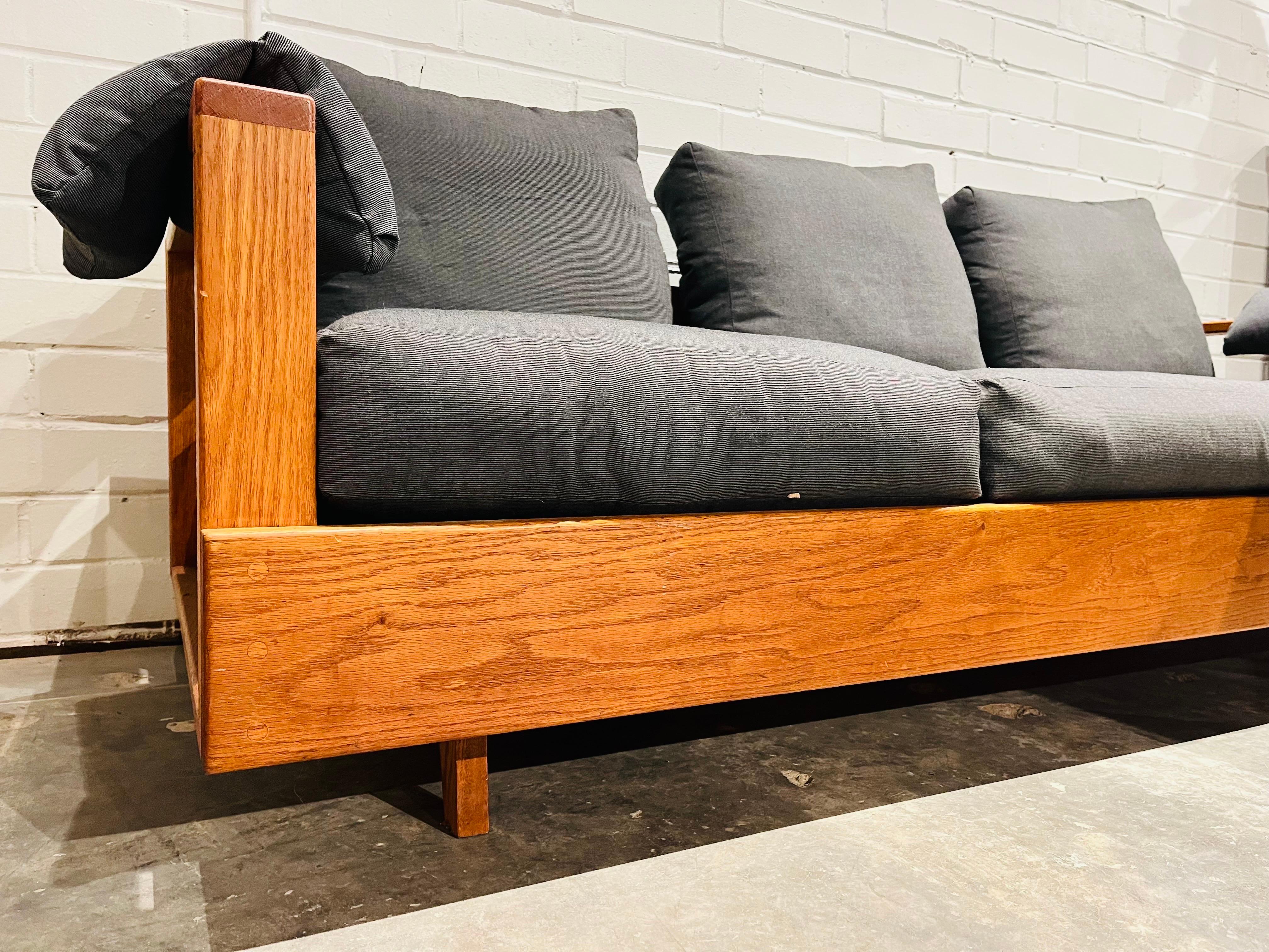 A unique, vintage, custom designed and hand built three seat wood frame sofa. The joinery in the construction of this sofa is truly beautiful as no fasteners are viewable. The solid wood frame has a twenty three inch high back. The feet of the sofa