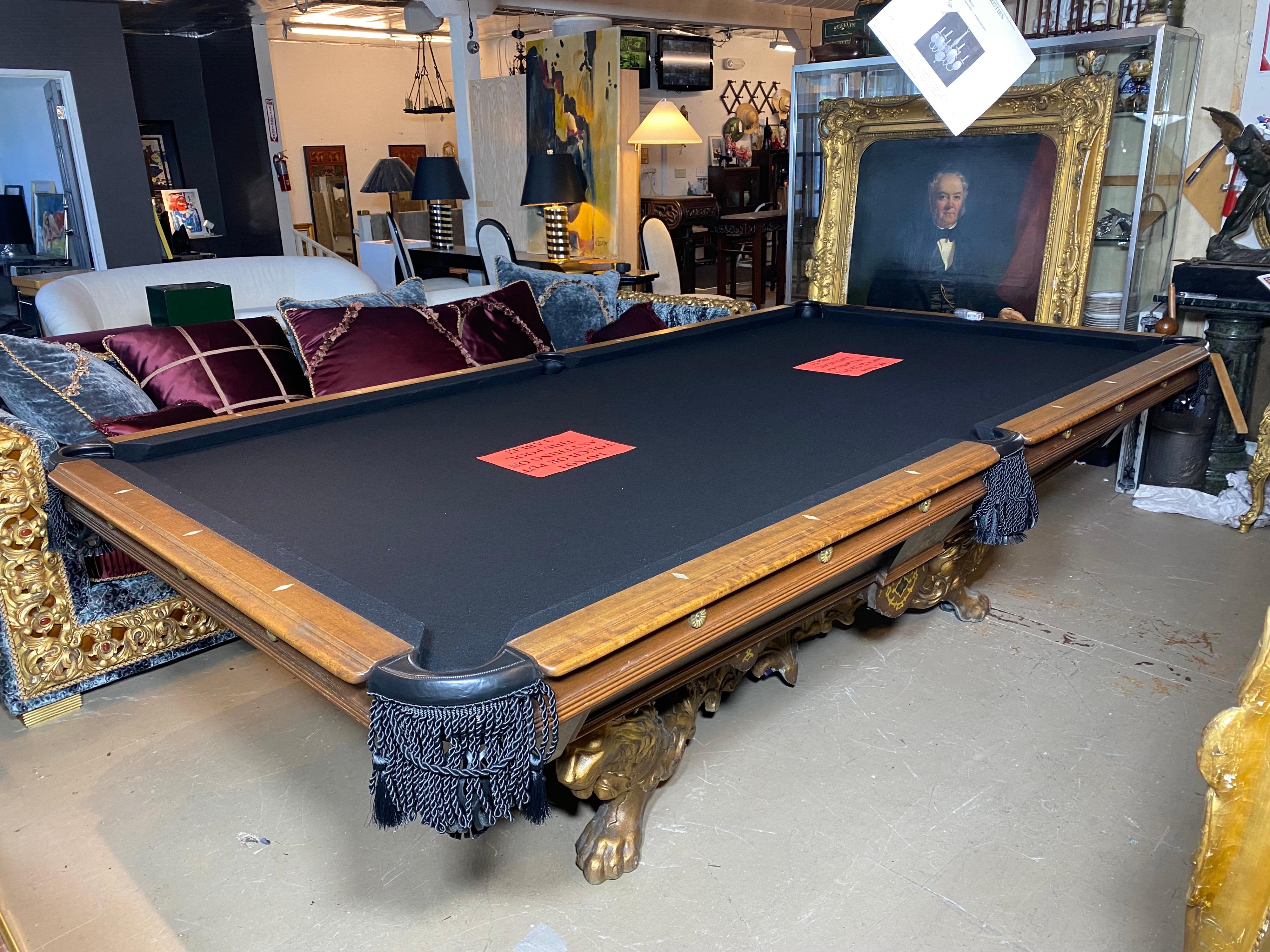 Vintage Custom 9’ pool table with a very ornate gilt cast Lion base. Restored to perfection having a rich and sophisticated appearance. The gilt lion base showing power and strength with the upmost class. The table is fitted with brand new pockets