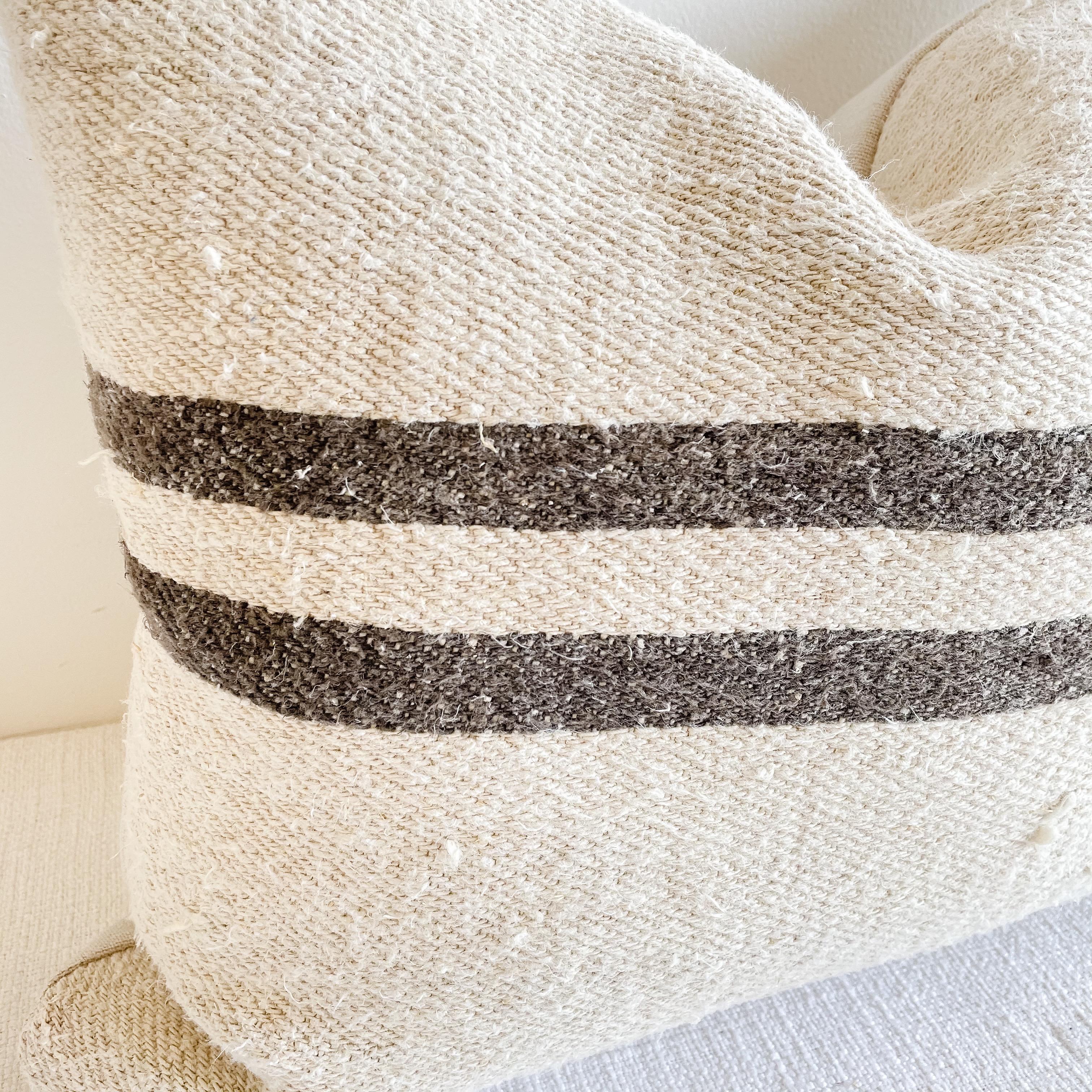 This beautiful vintage grainsack pillow is made from a European farmers grain bag with stripes, and original stipes, and some vintage grain sacks may show original patches or monograming. See photo details.
Color: Natural flax with deep brown