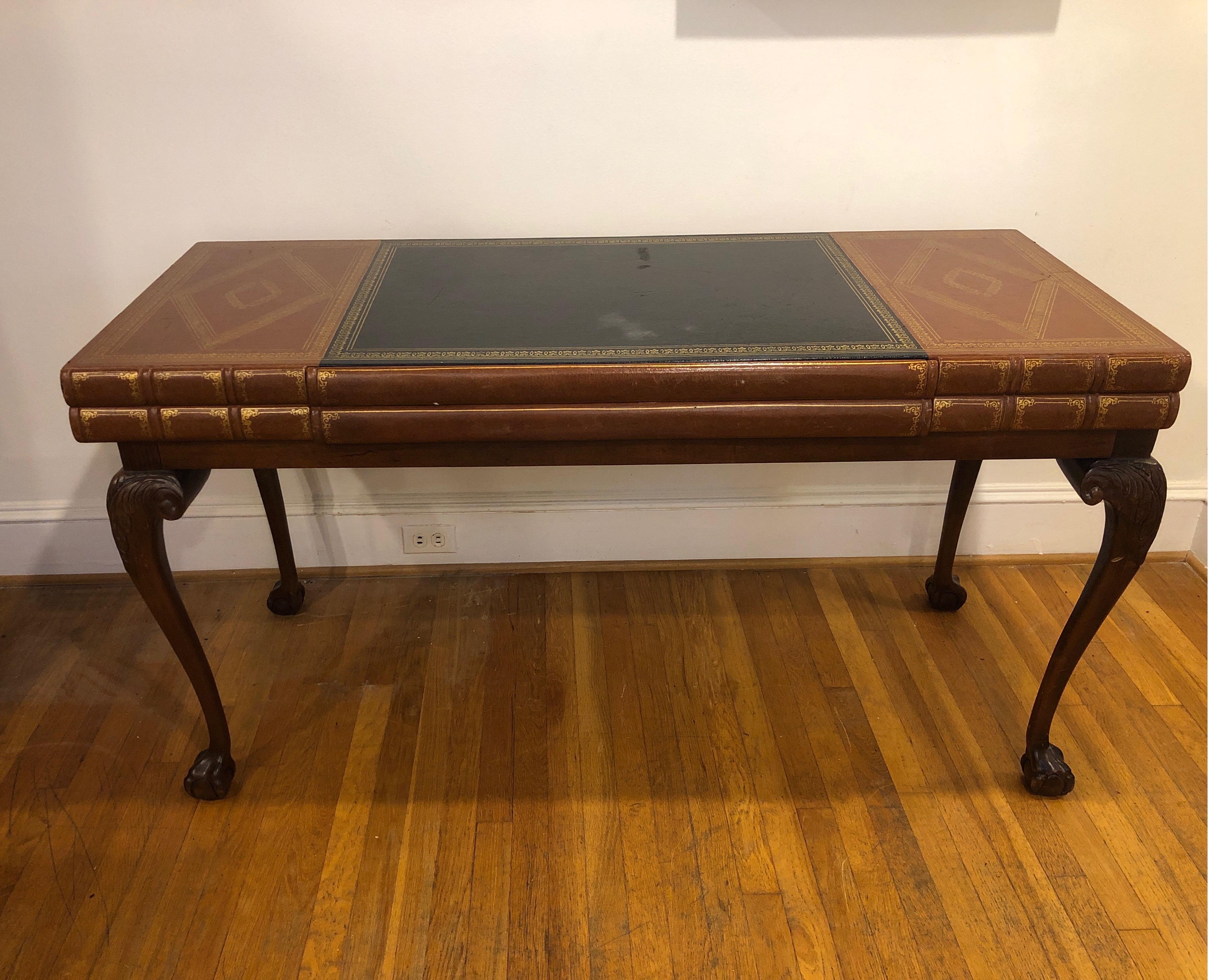 Rare custom made vintage desk by Pulaski. Styled after Theodore Alexander/Maitland Smith with tooled leather bound antiquarian stacked books, with a storage drawer. 
A rare version of this classic, on Georgian style wooden claw and ball legs. This