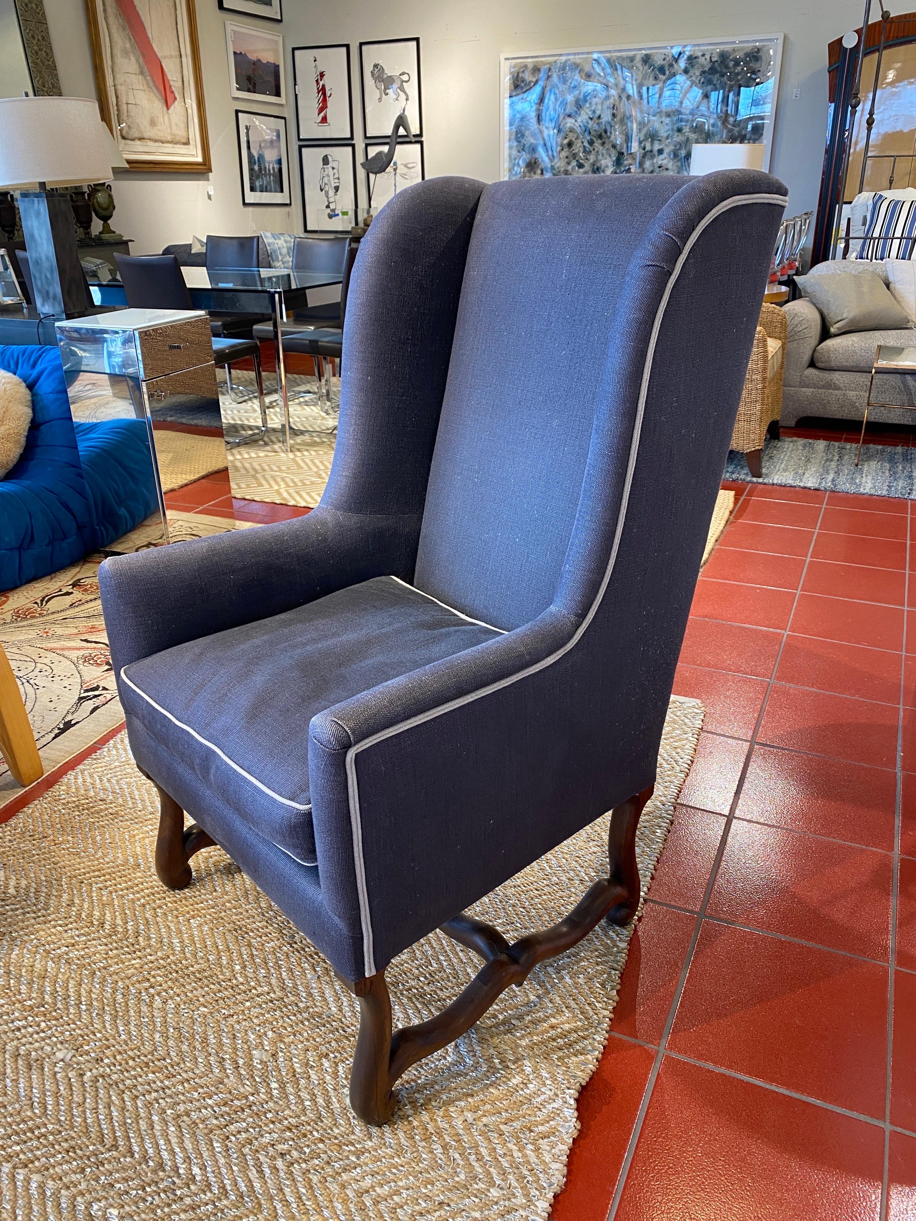 Vintage custom Swedish wingback chair. Unique wood work on legs, gorgeous gray/blue fabric with light piping.
.