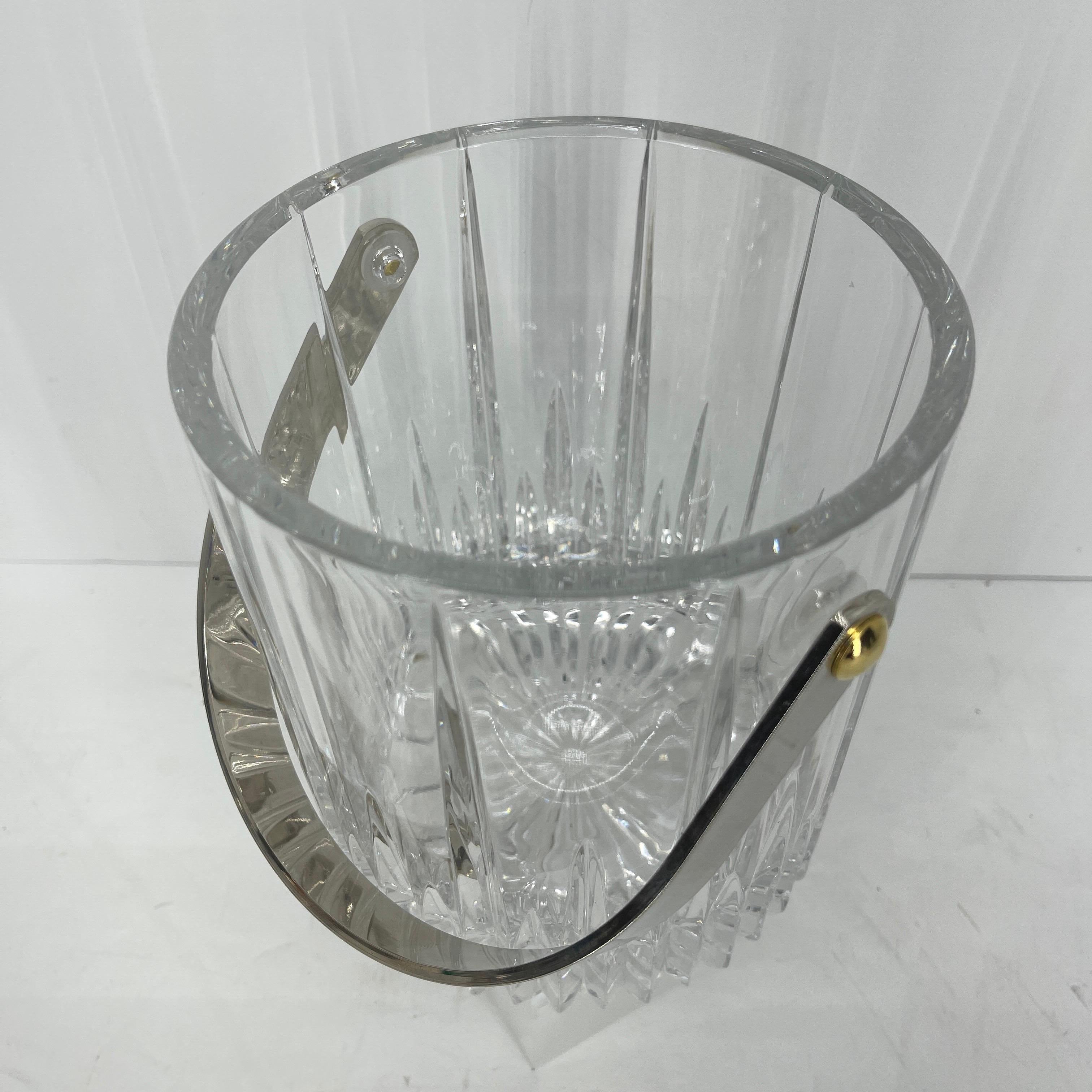Mid-Century Modern cut crystal ice bucket. This ice bucket in the style of Saint Louis of France has heavy polished chrome handle and brass fittings. The design and shape of the cut crystal shines in the daylight as well as candlelit evenings.
