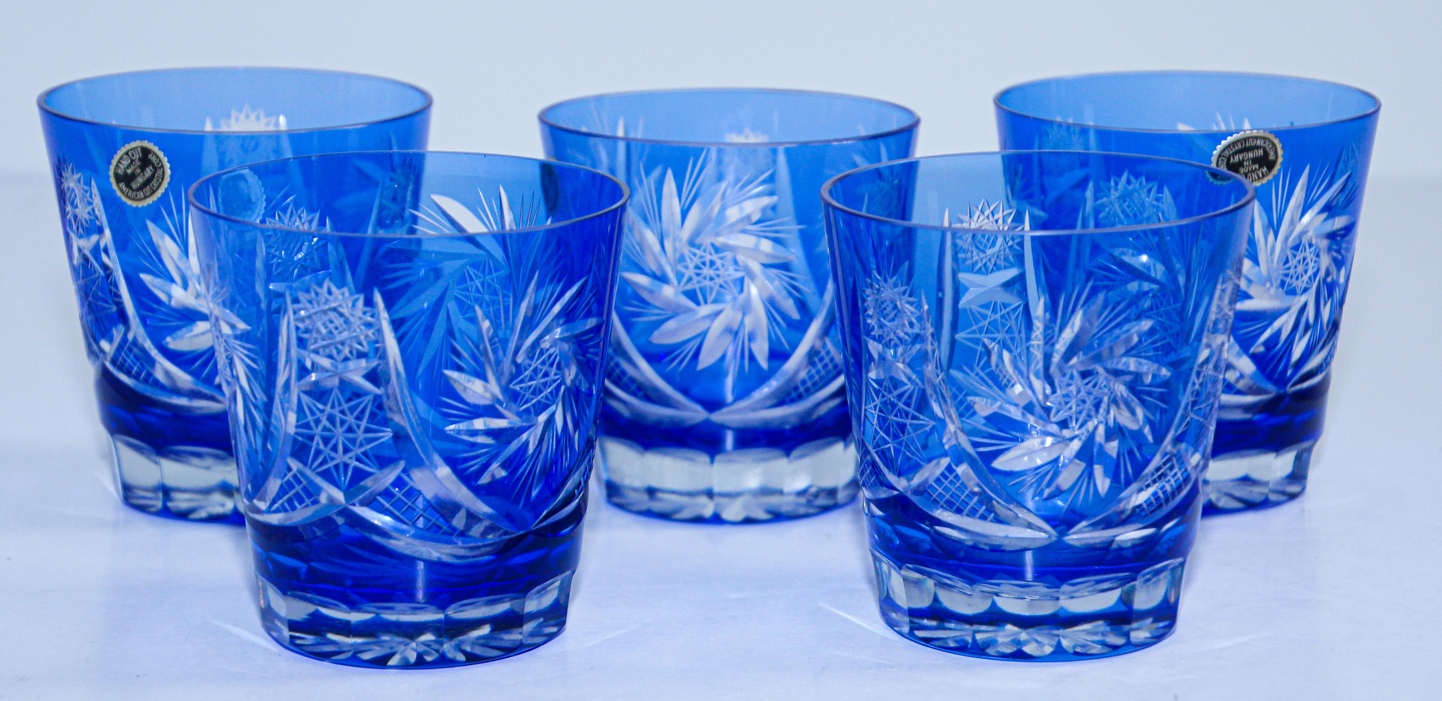 Set of five vintage whiskey glasses tumbler cobalt blue crystal Baccarat style. 
The vibrant hand blown rich sapphire blue jewel sapphire blue crystal glass is cut to clear to reveal a lovely pattern with clean lines. 
Set of five rock whiskey