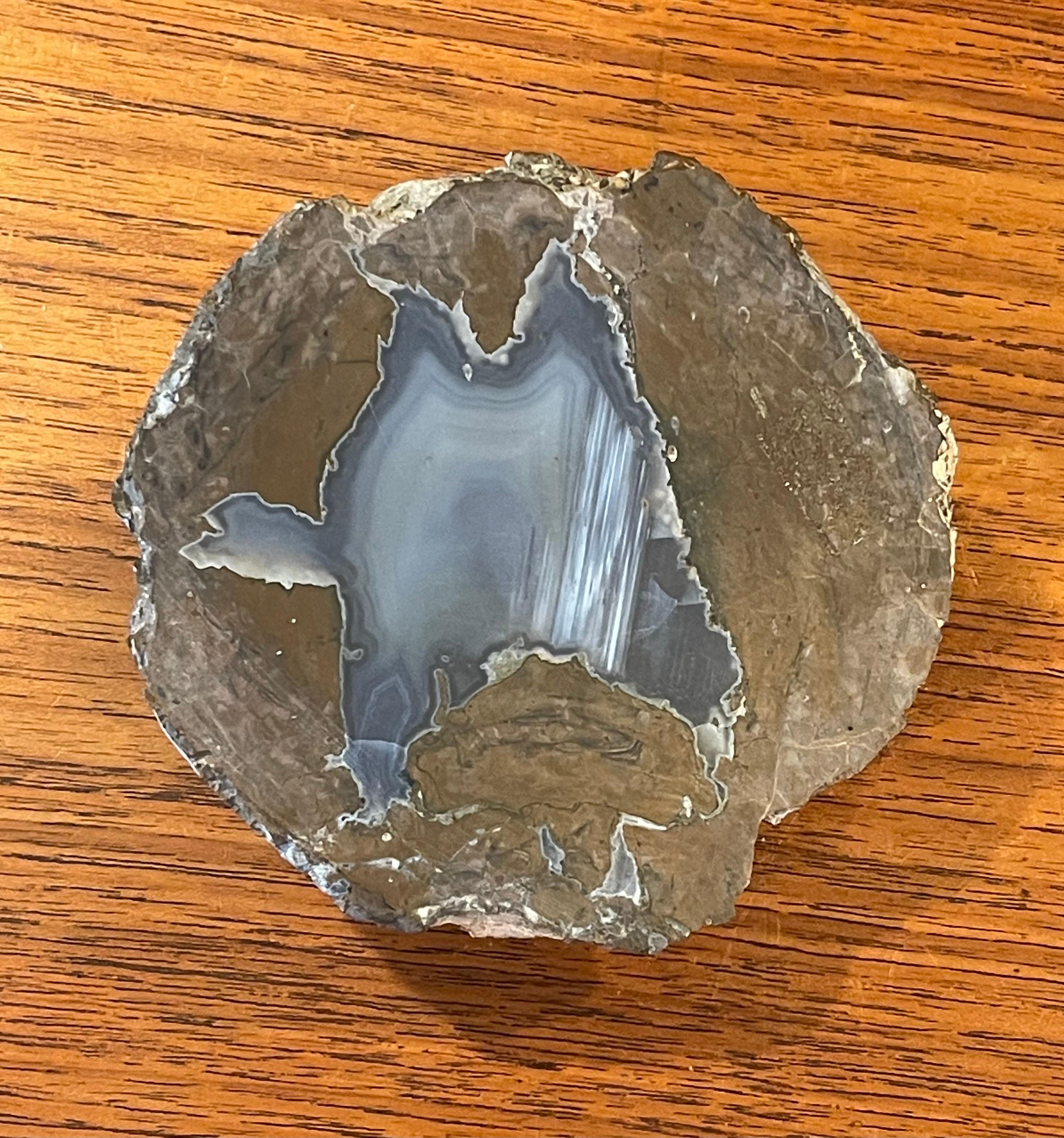 A very nice vintage cut geode paper weight, circa 1960s. The piece is in very good condition with wonderful brown, tan, grey and blue colors and measures 4.25