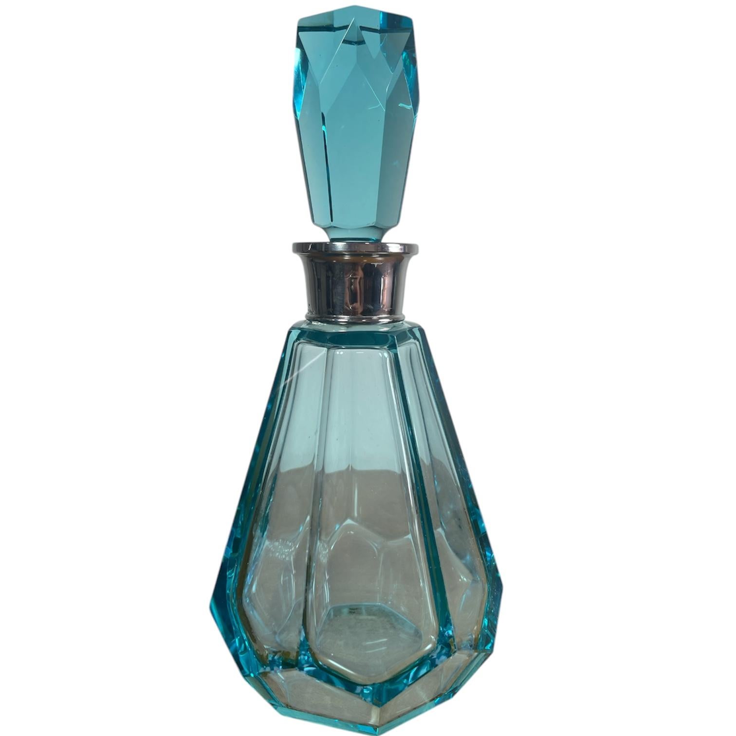 A unique addition to any bar, the trendy teal color and vibrant hues make this a sculptural decanter, ideal for serving cocktails or your favorite spirits.