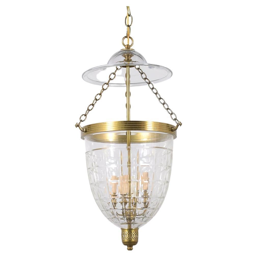 Discover our extraordinary vintage 1950s Regency-style pendant lantern, meticulously handcrafted from glass and maintained in excellent condition by our expert craftsmen. This beautiful lighting fixture showcases intricate engraving on a round glass