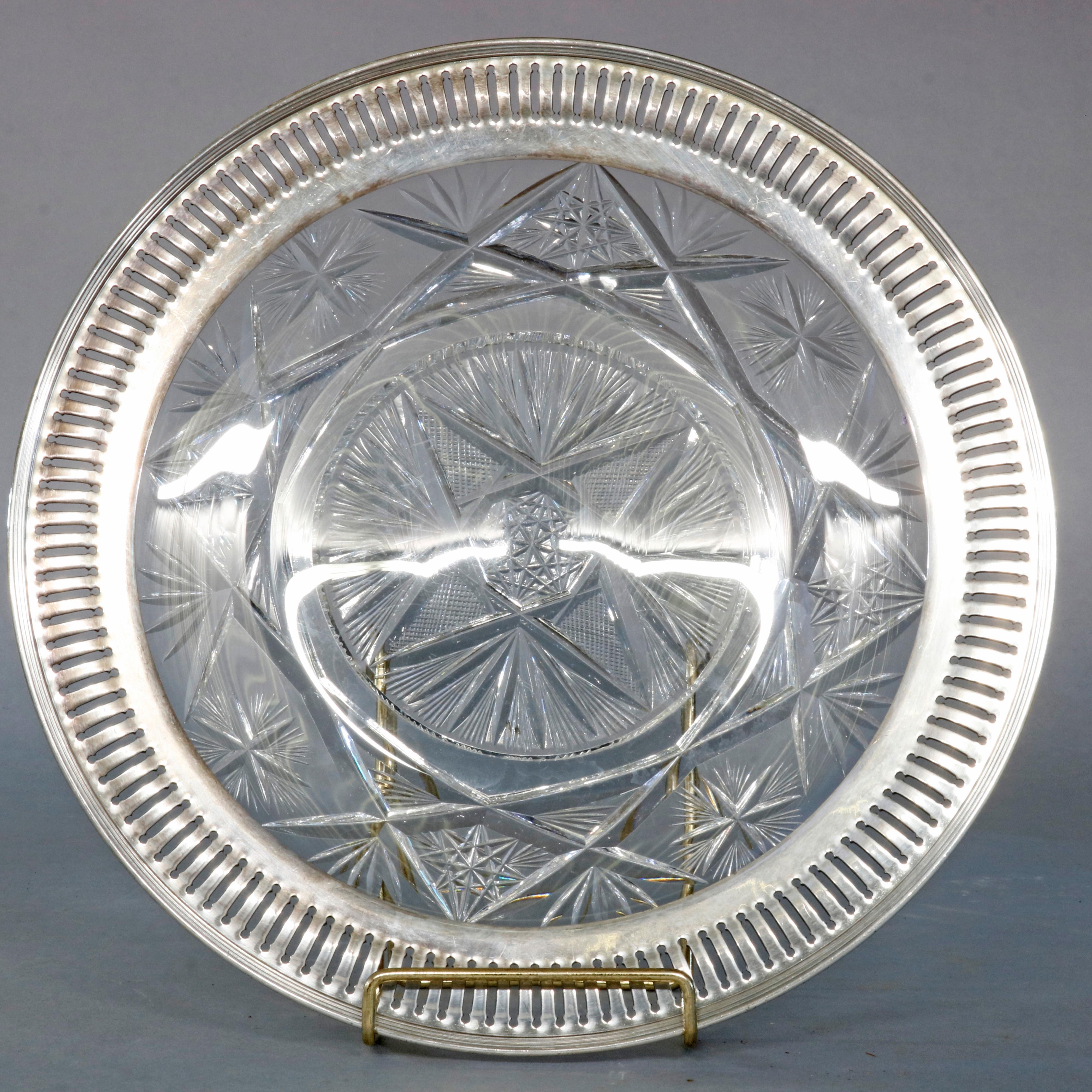 A vintage serving tray offers reeded sterling silver rim surrounding cut glass base with star pattern, circa 1940

Measures: 1