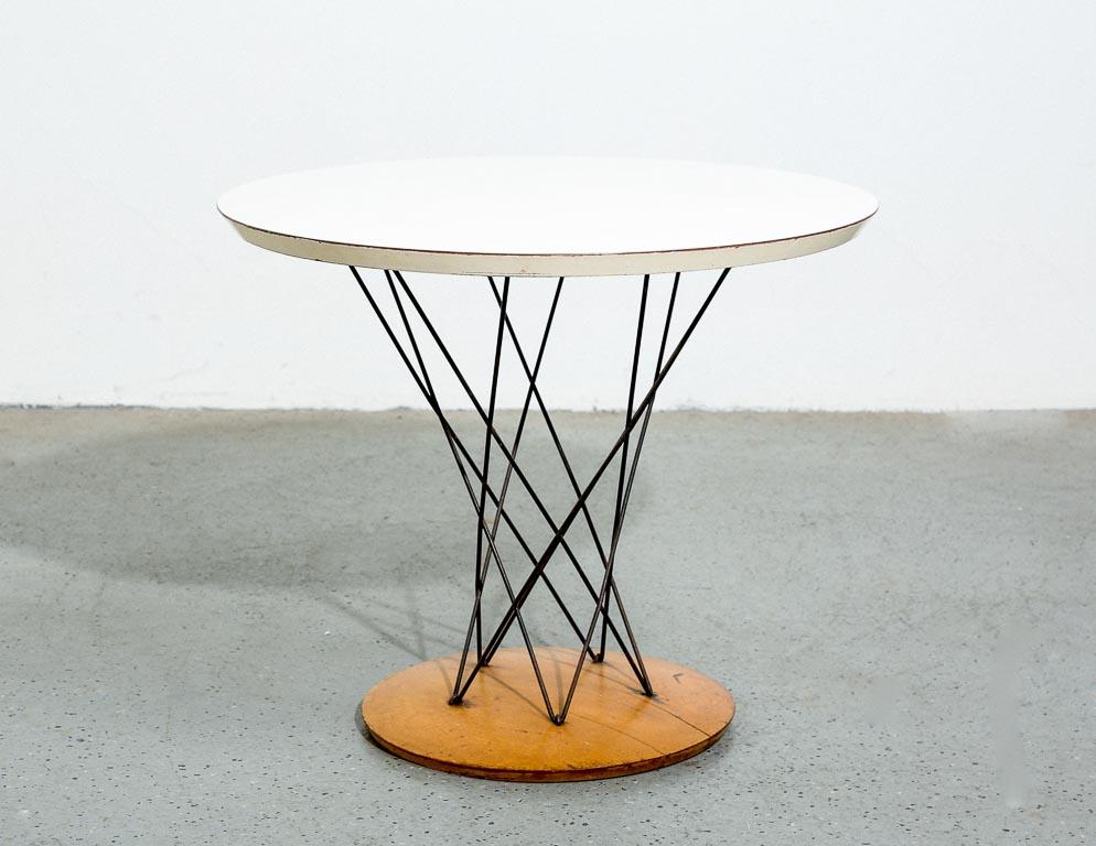 Vintage Cyclone side table by Isamu Noguchi for Knoll. Unpainted wood base with steel rod cyclone pedestal. White laminate top.