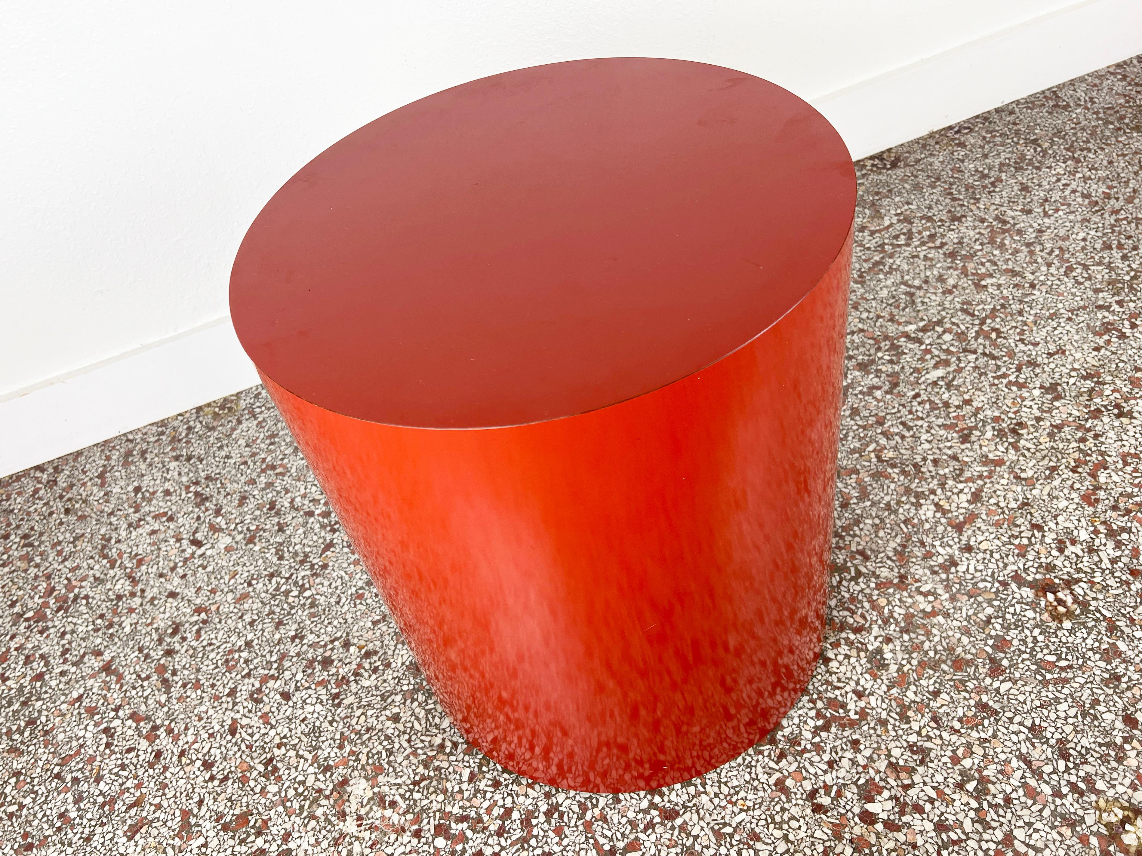 Vintage cylindrical red-orange laminate drum table.

Year: 1970s

Origin: USA

Style: Mid-Century Modern

Dimensions: 18.25