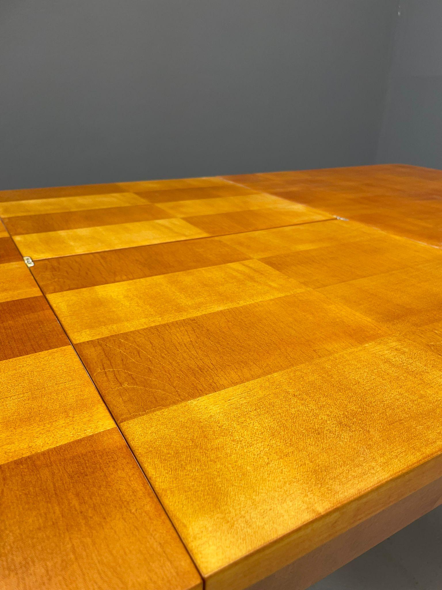 This mid-century extendable dining table designed by Jindřich Halabala is a stunning example of Czechoslovak modernist furniture from the 1940s–1950s. It features a beautifully executed checkerboard veneer top, a hallmark of Halabala’s refined sense