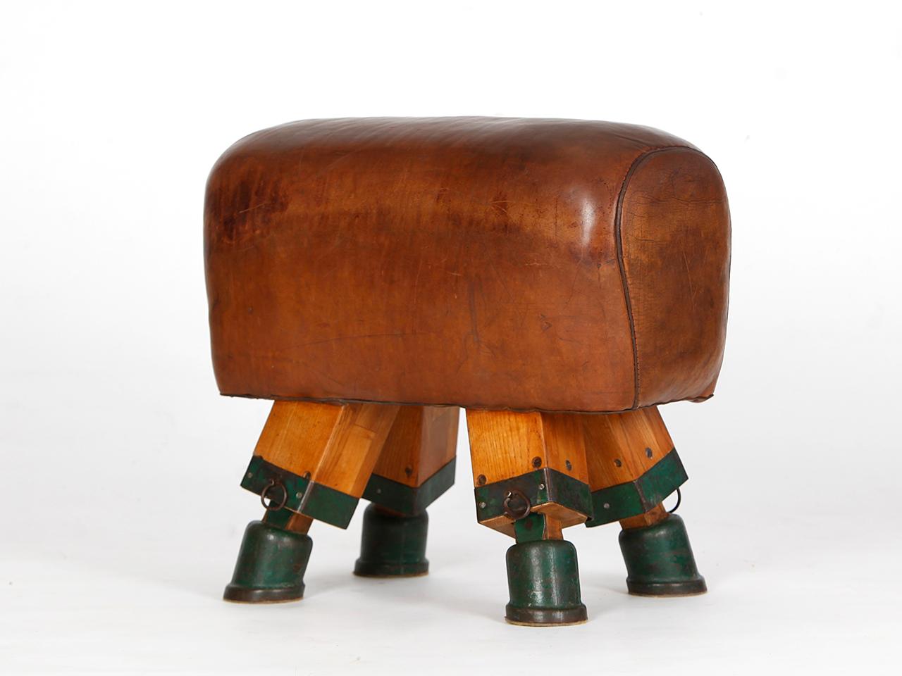 This Czech gym stool or turn bock was produced in the 1930s. It has been shortened to a height of 55 cm. The iron feet are preserved. The thick cowhide has been cleaned and preserved and has a very nice patina. All of our premium vintage gym