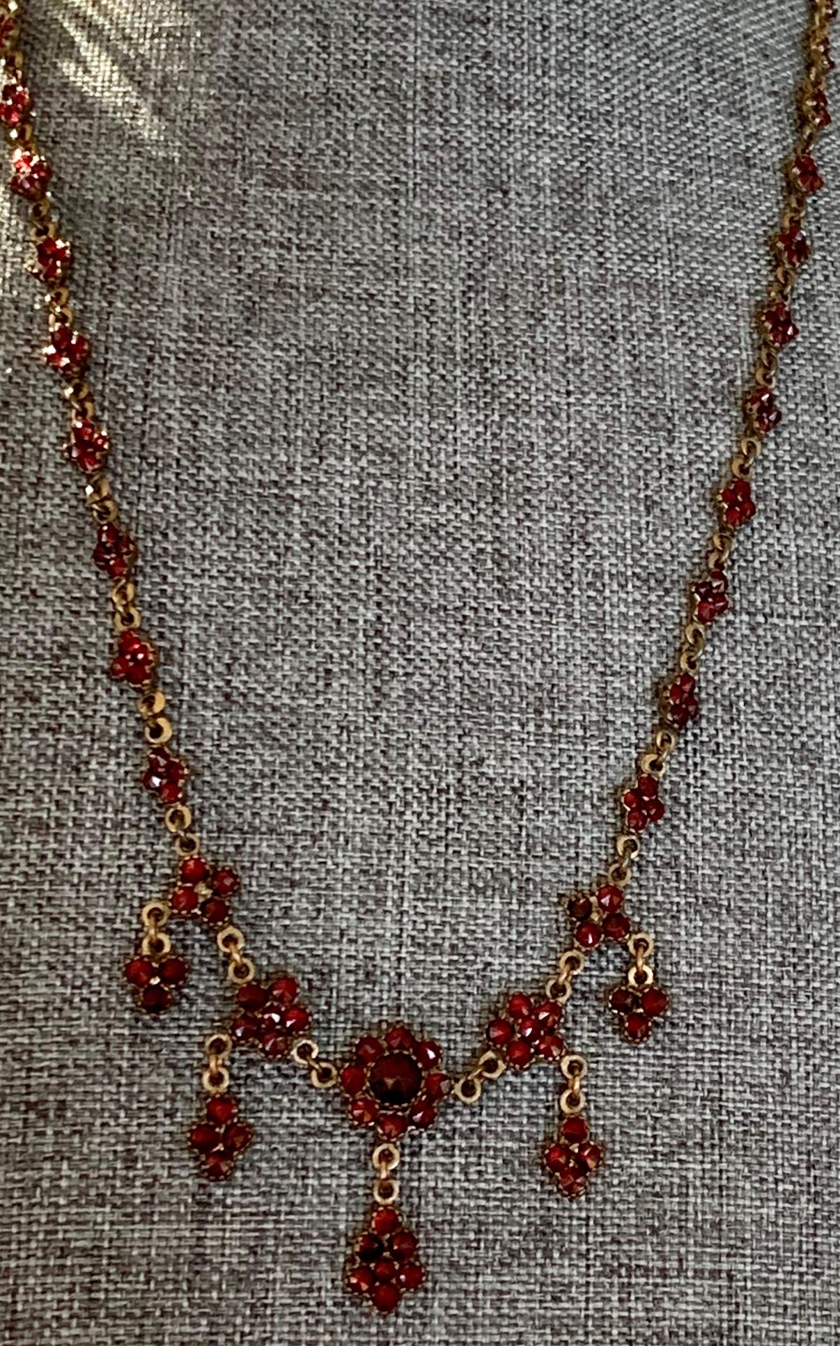 This vintage Czechoslovakian Garnet necklace is stunning.  It has five, nearly identical dangles.  The center stone and dangle is just a little larger than the other four.  The necklace is Gold washed, Gold filled.
Length: 22