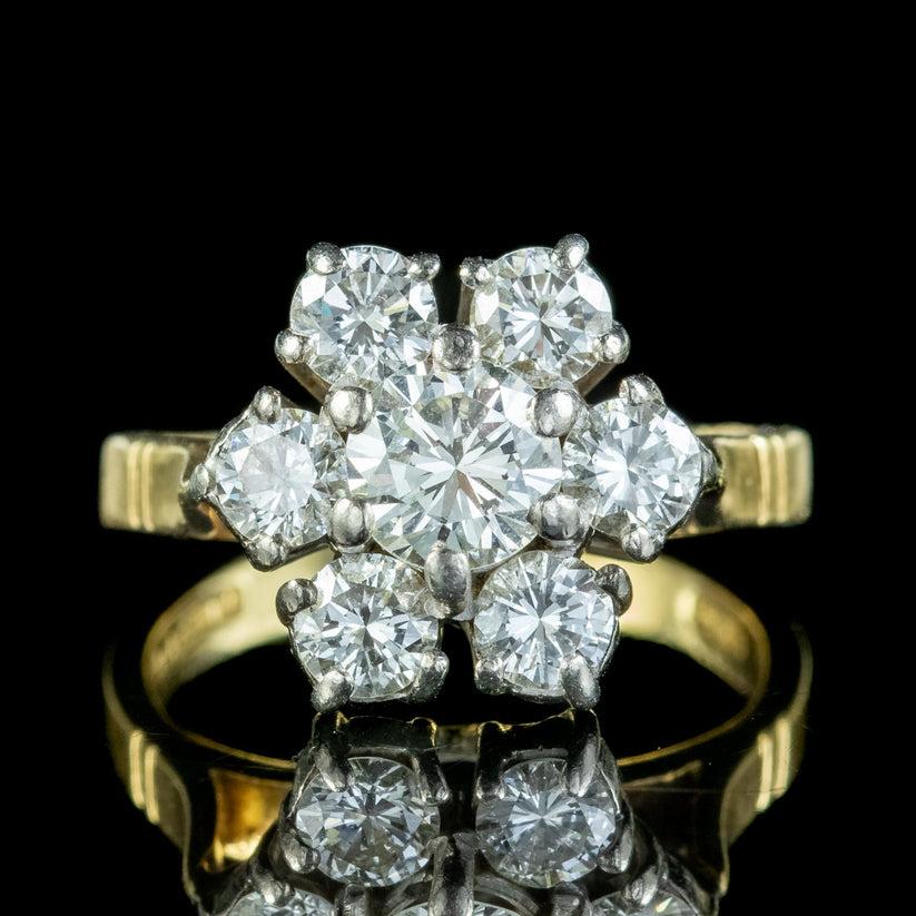A glorious vintage daisy cluster ring from the 1980s adorned with seven dazzling brilliant cut diamonds that are exceptionally bright and clean with VS 1 clarity – I colour. The centre stone weighs approx. 0.70ct, with 0.20ct petals, making a grand