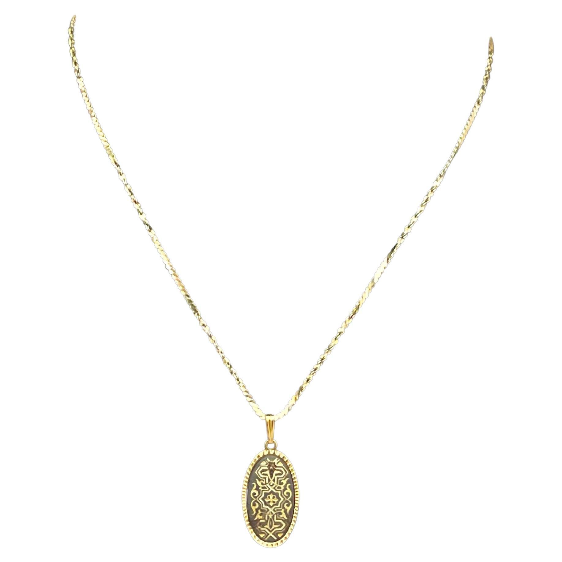 This Vintage Damascene Oval Necklace is a beautiful and unique piece of jewelry that showcases the intricate artistry of Damascene metalwork. This type of necklace features an oval-shaped pendant or design, crafted using the classic Damascene