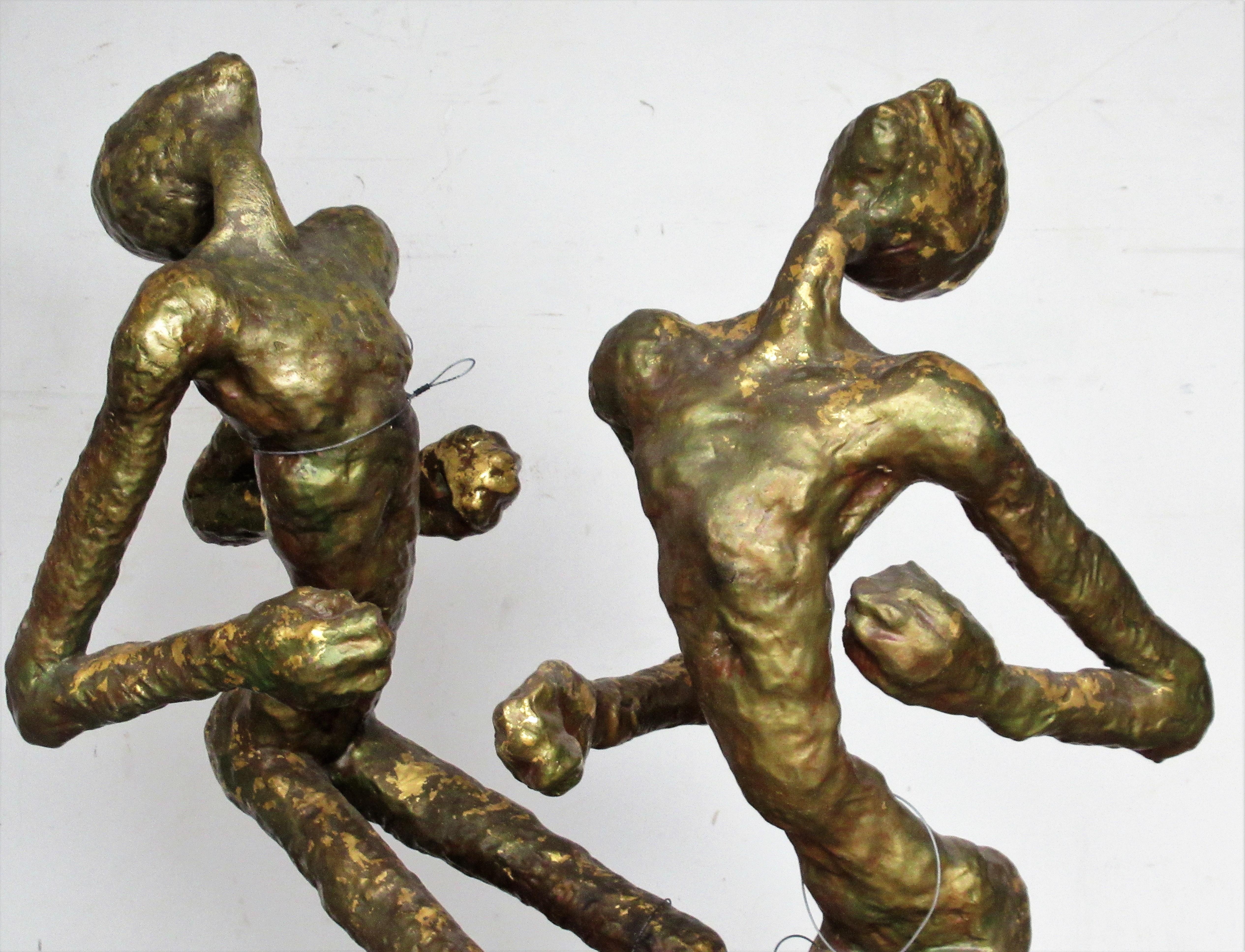 Vintage handcrafted gilded and bronzed brass clad metal large figural props ( over 40 inches high ) with dynamic sculptural motion that look great from all angles. These were purportedly used by the internationally acclaimed dance theater