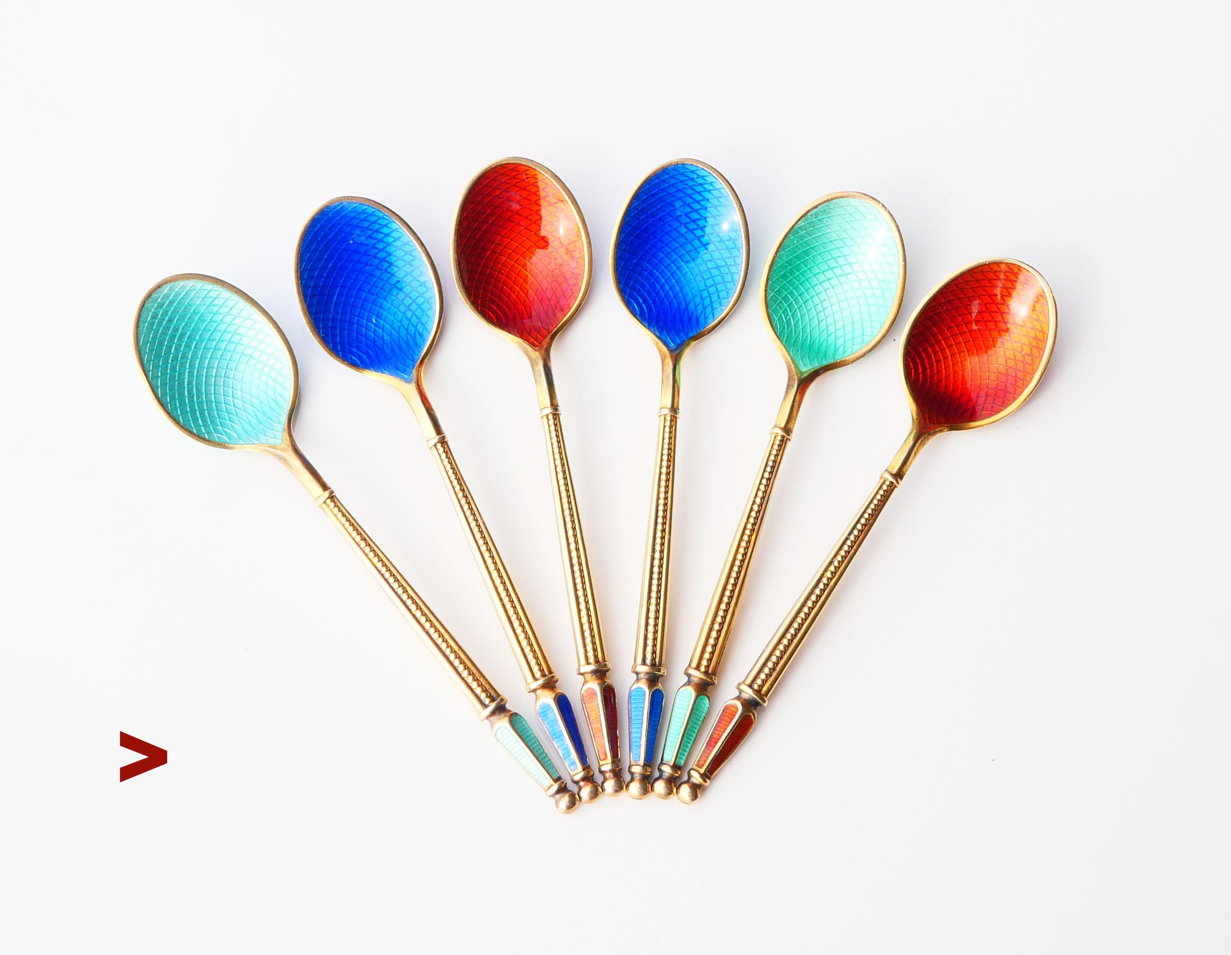 
Danish set of fine tea/ ice - cream spoons solid Gilt 925 grade Silver decorated with translucent Guilloche Enamels.  Hand - made at the workshop of A. Michelsen, Copenhagen, DK. Hallmarked with maker's hallmarks that confirm solid 925  Sterling