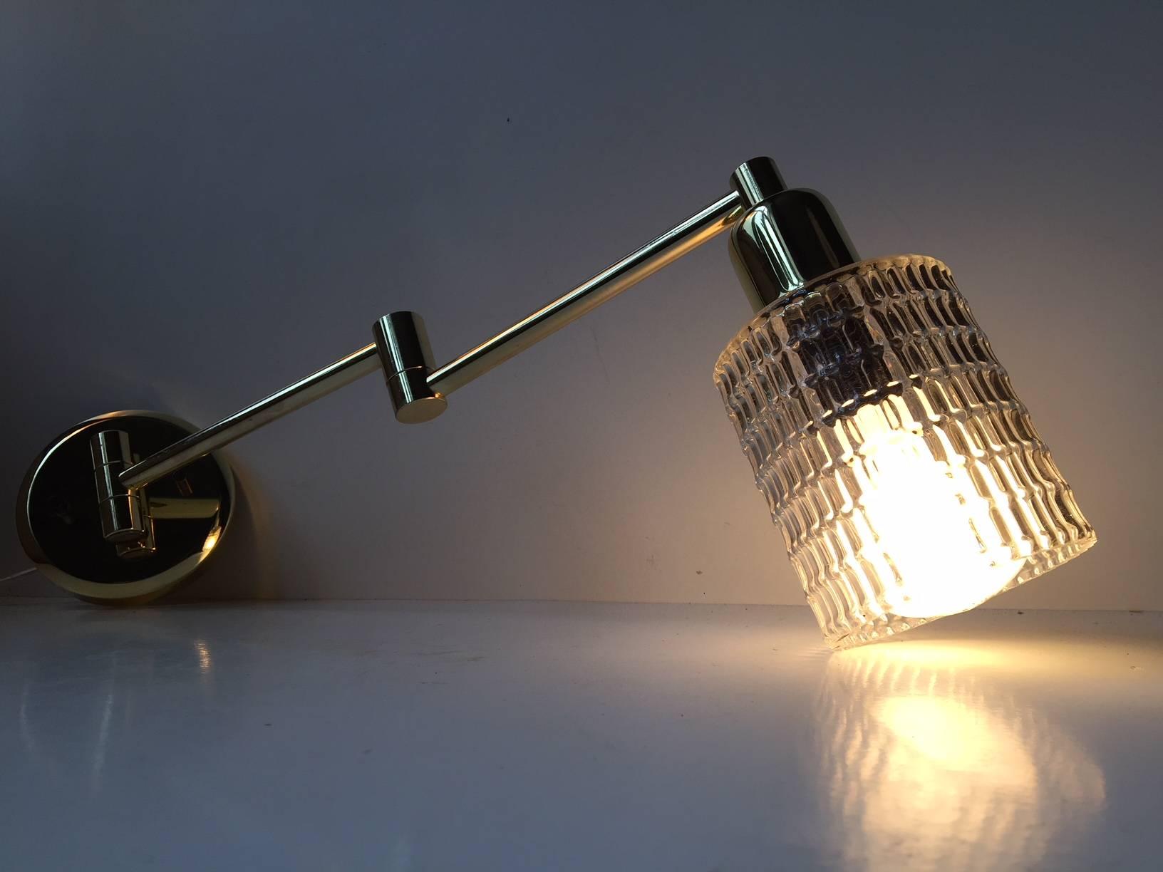 Adjustable angle poise wall light. Made of polished solid brass. Mounted with a diamond patterned clear glass shade. Manufactured by ABO metal art in Denmark during the 1980s.