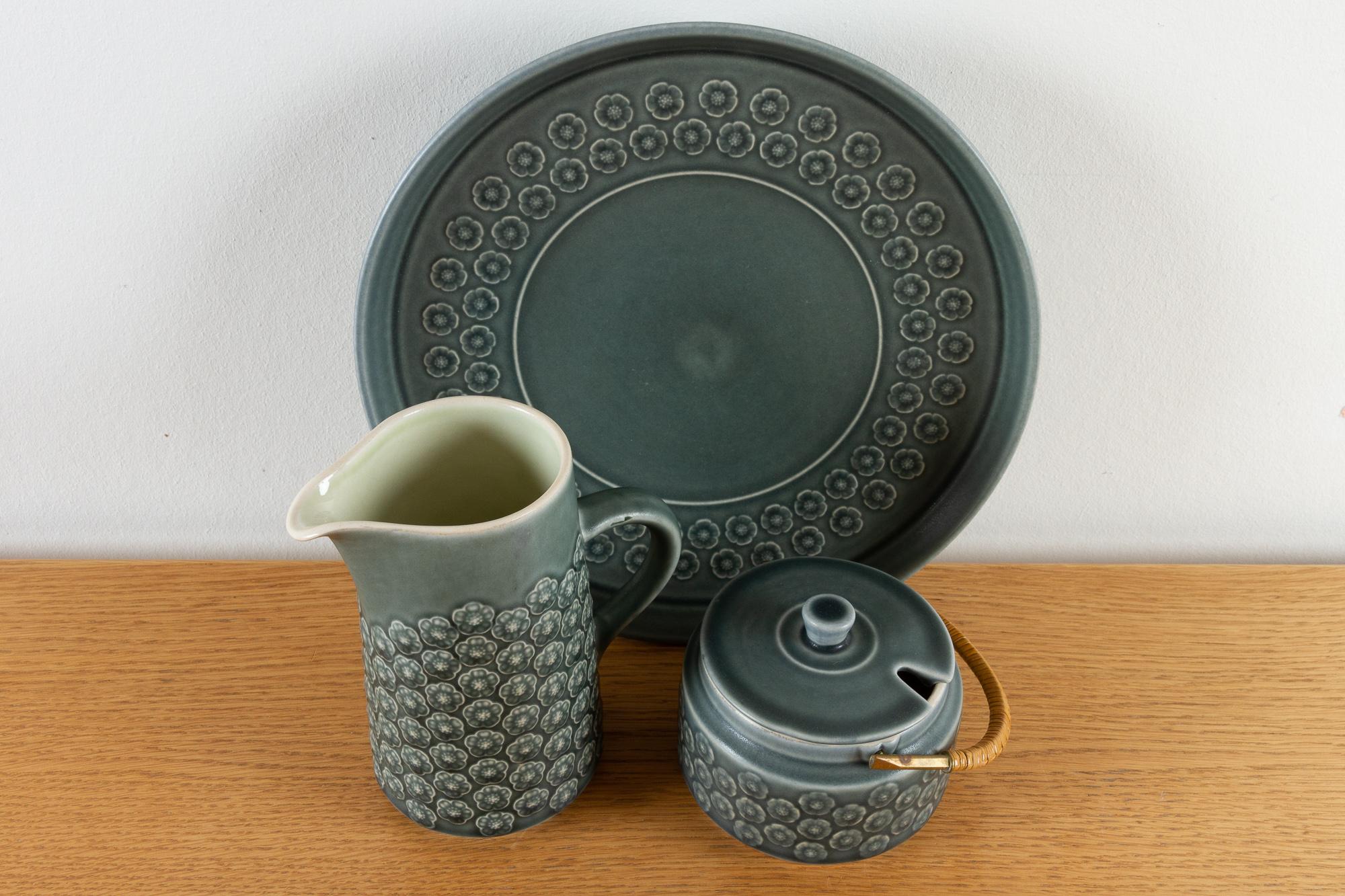 Vintage Danish Azur Stoneware by Jens H. Quistgaard for Kronjyden, 1960s

Three pieces of Azur stoneware from the early production at Kronjyden, Denmark.
One plate/serving dish, one milk jug and one marmalade or sugar bowl with lid and cane