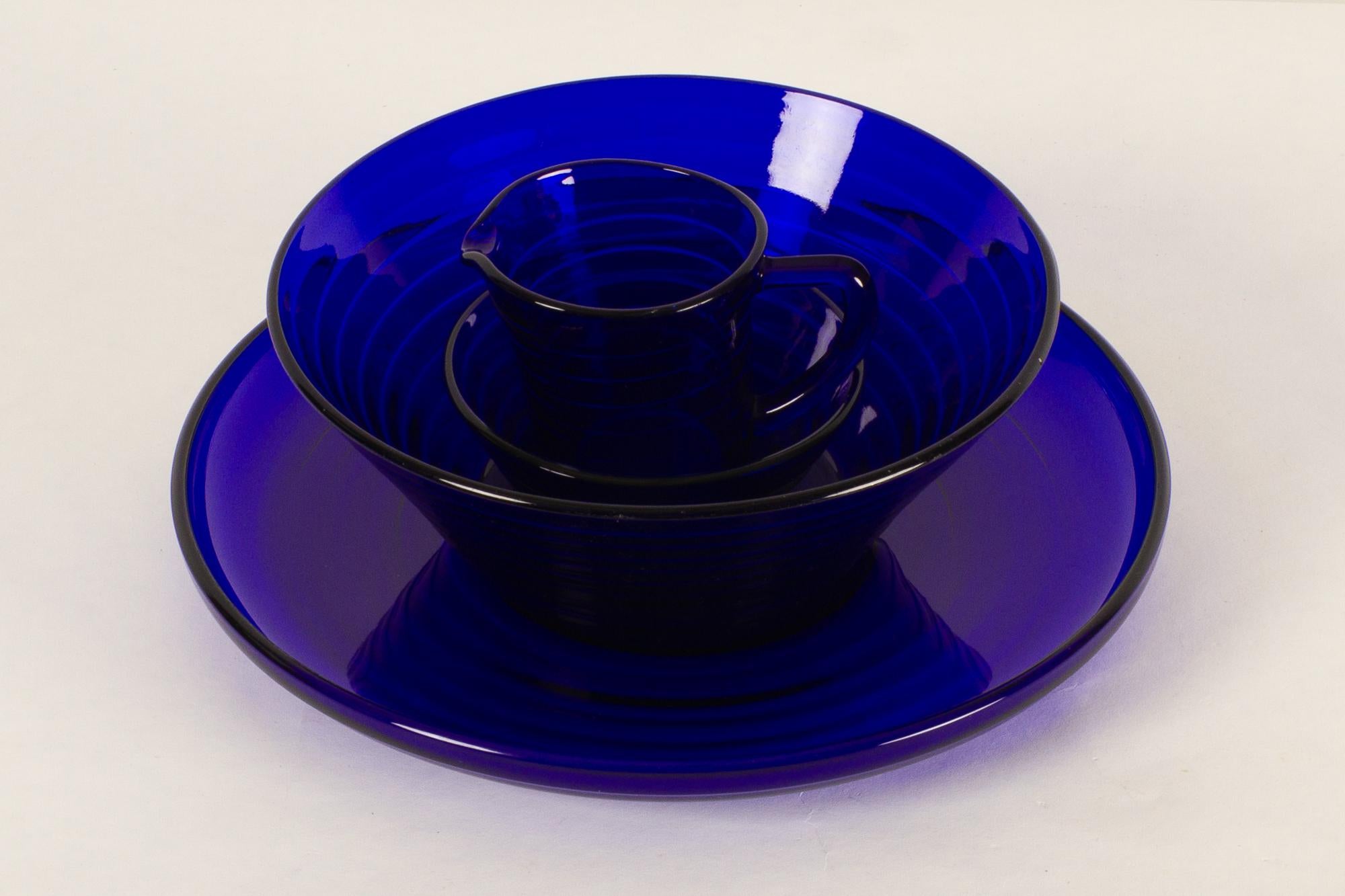 Vintage Danish blue glass set 1930s Set of 4.
Danish blue glass set model Broksø designed by Jacob E. Bang in 1938 for Holmegaard Glassworks in Denmark.
This set consists of:
A small bowl, diameter 11.5 cm.
A small pitcher, height 8.5.
A