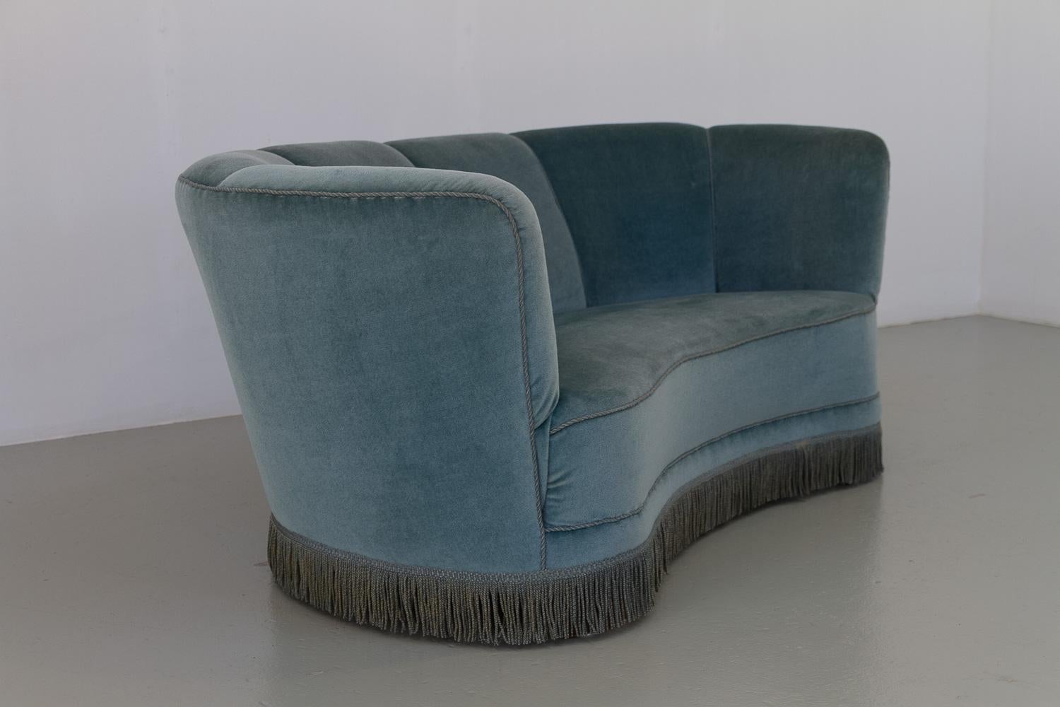 Vintage Danish Blue Velvet Art Deco Banana Sofa, 1940s.

Vintage Art Deco banana-shaped loveseat upholstered in light aqua blue mohair velvet made by cabinetmaker in Denmark in the 1940s. Curved two-seater with original coil springs and velour
