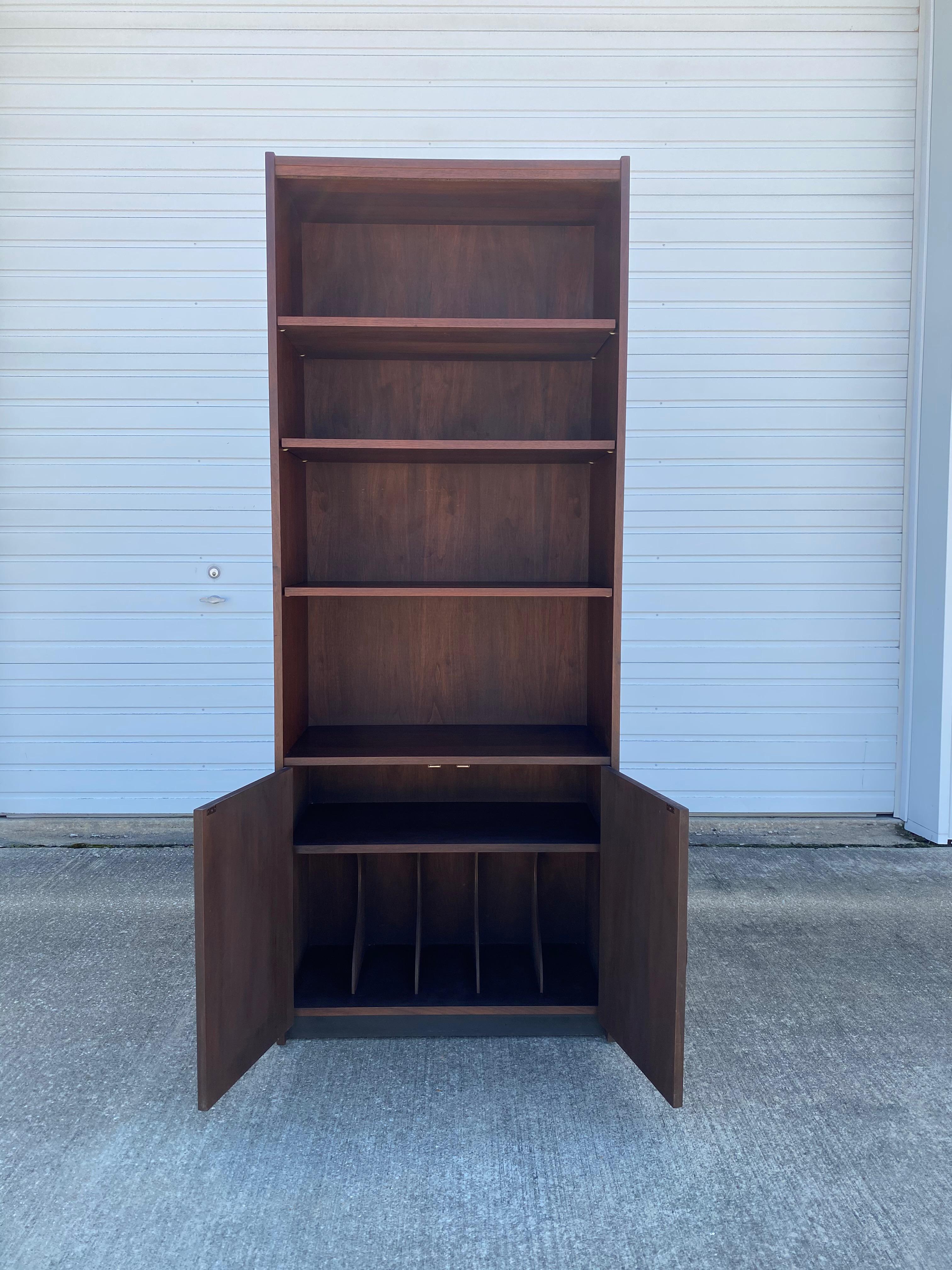 Beautiful Danish modern bookcase and cabinet. Inside the cabinet holds a file divider, which makes this piece pretty unique! The four shelves can be moved to any height you please. The bottom of the shelf has a black detail to make it look like it