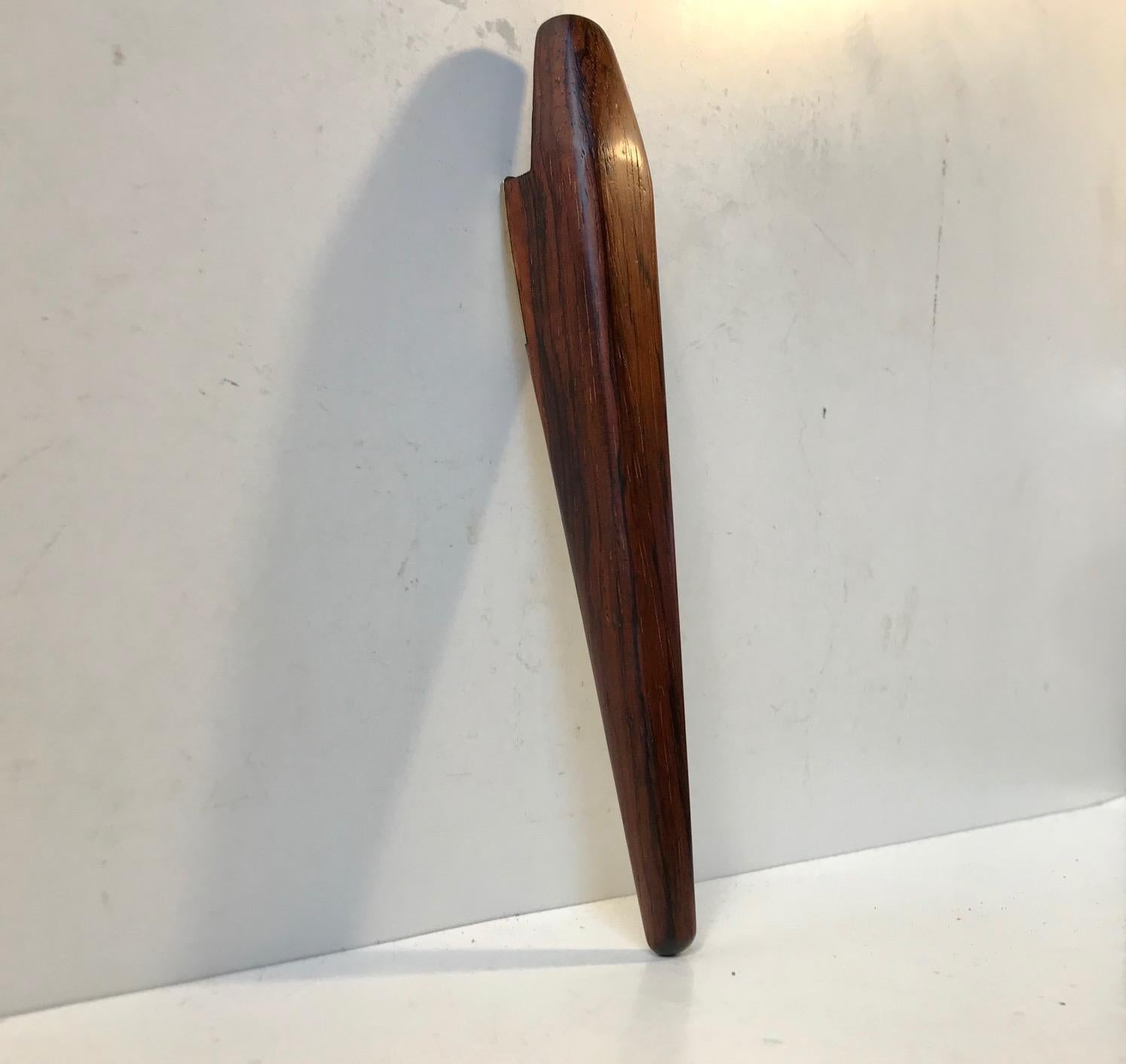 High quality handmade bottle opener in rosewood and brass. Designed by Poul Knudsen in Denmark during the 1960s.